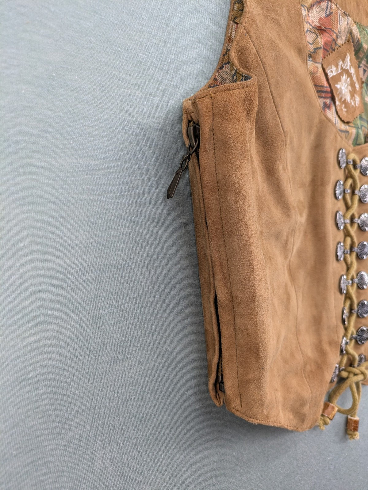 St. Moritz multi Trachtenweste brown genuine leather with decorative lacing and colorful satin lining.