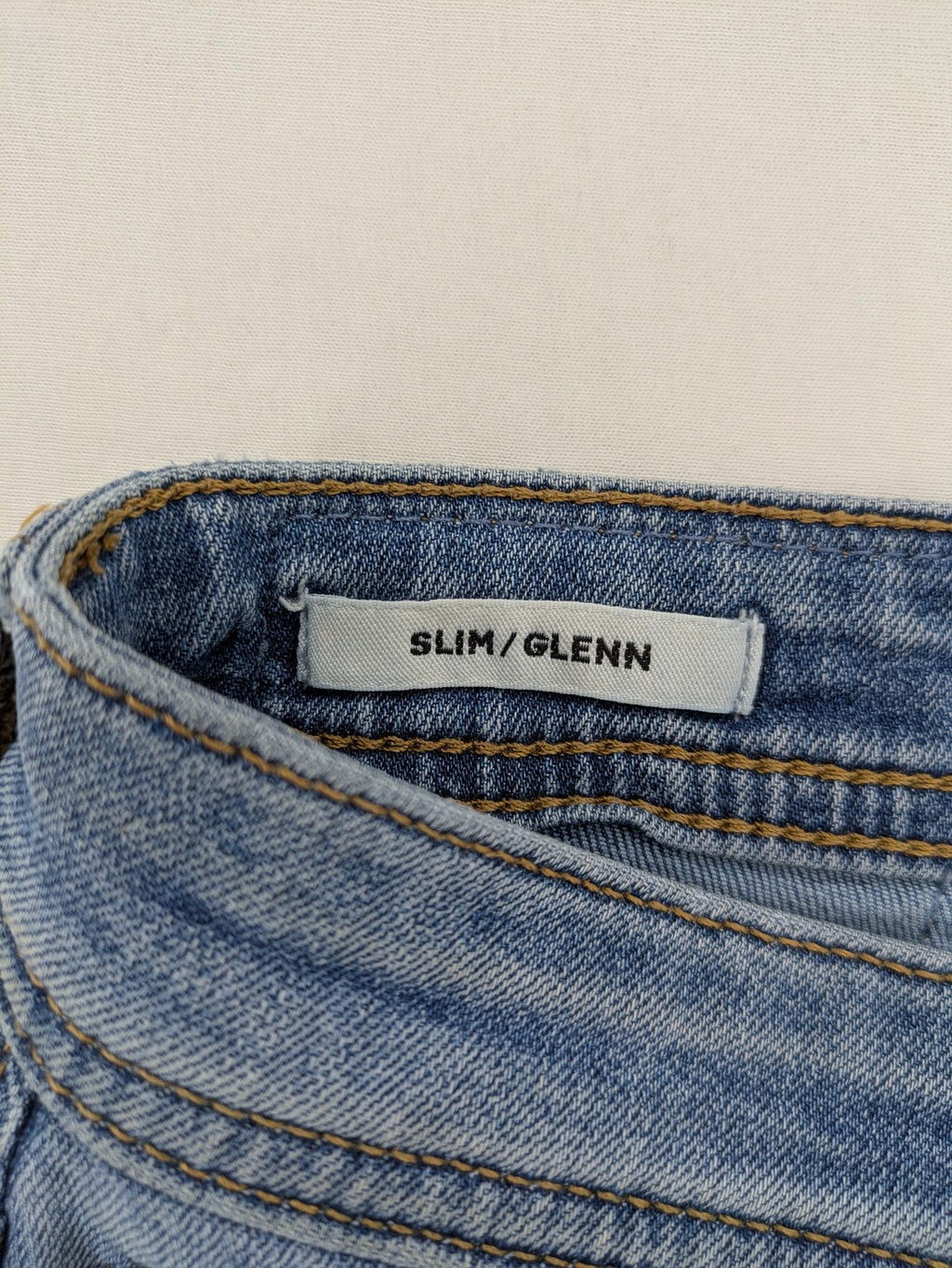 Jack & Jones blue slim jeans with button fly and subtle used look.
