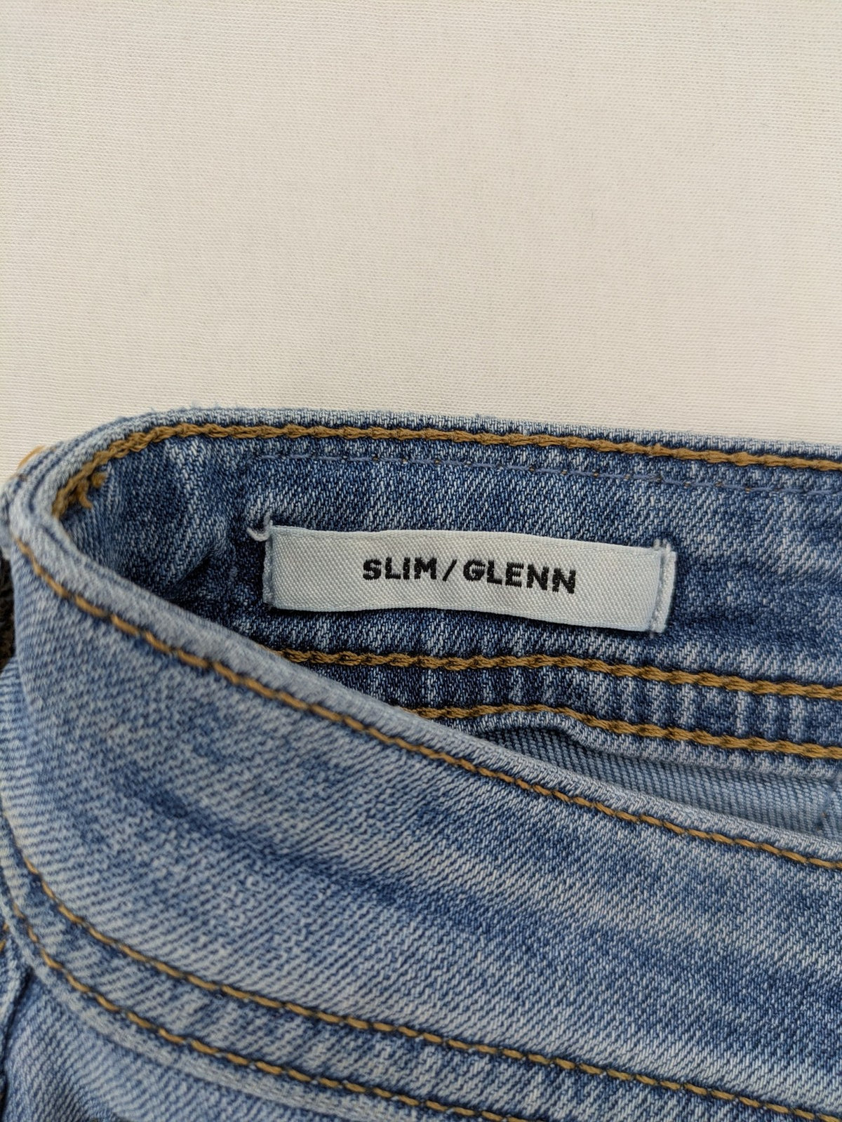 Jack & Jones blue slim jeans with button fly and subtle used look.