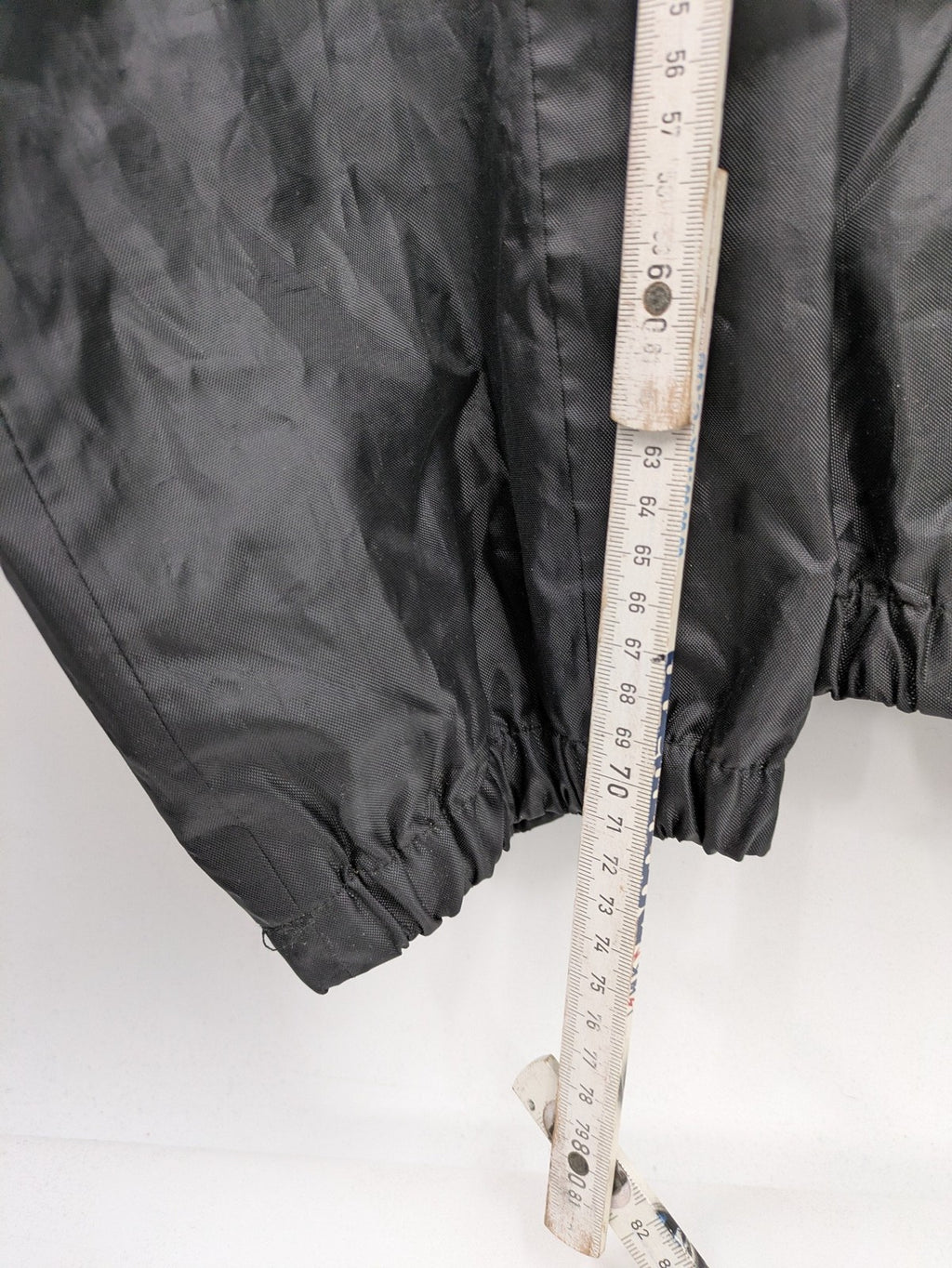 Unitech black rain suit with red reflective stripes and full zipper, size M.