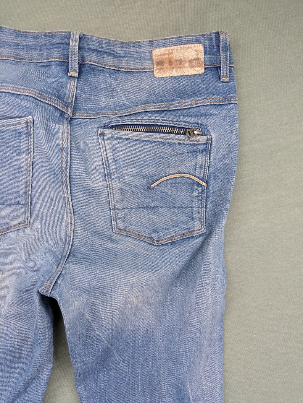 G-Star Raw blue slim skinny jeans with light wash and signature back zip pocket.