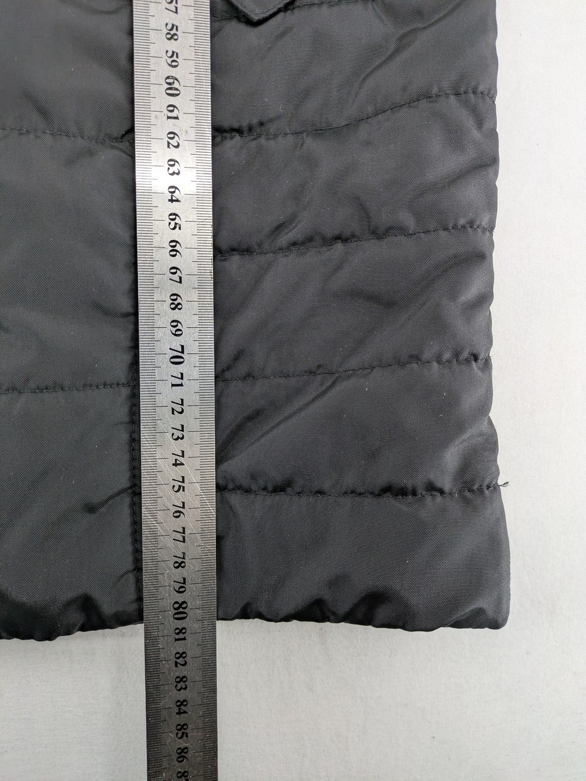 Vero Moda black quilted jacket with hood, reflective stripes, nylon material.
