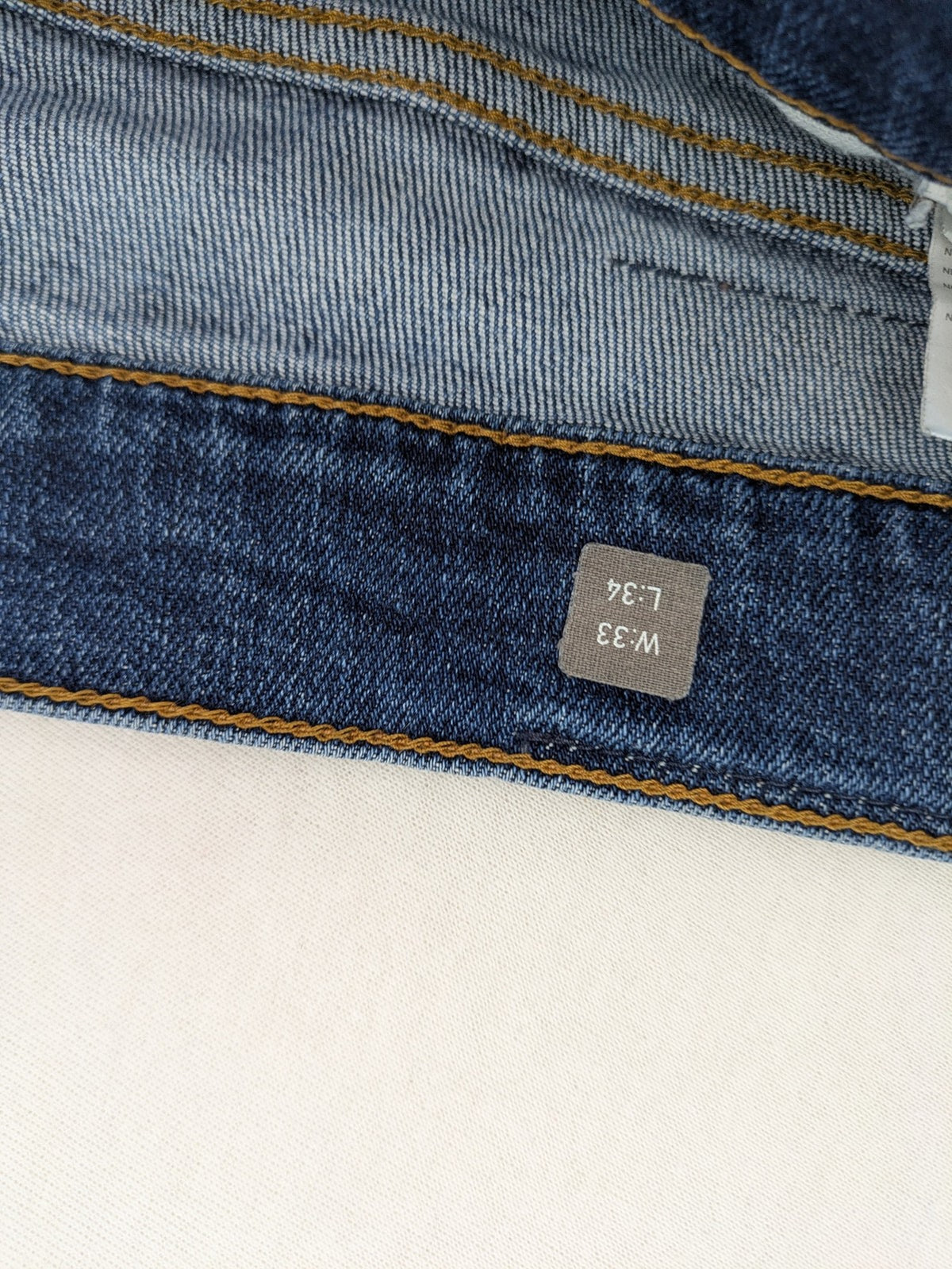 Mustang blue tapered jeans with slim fit, medium rise, and classic denim texture.