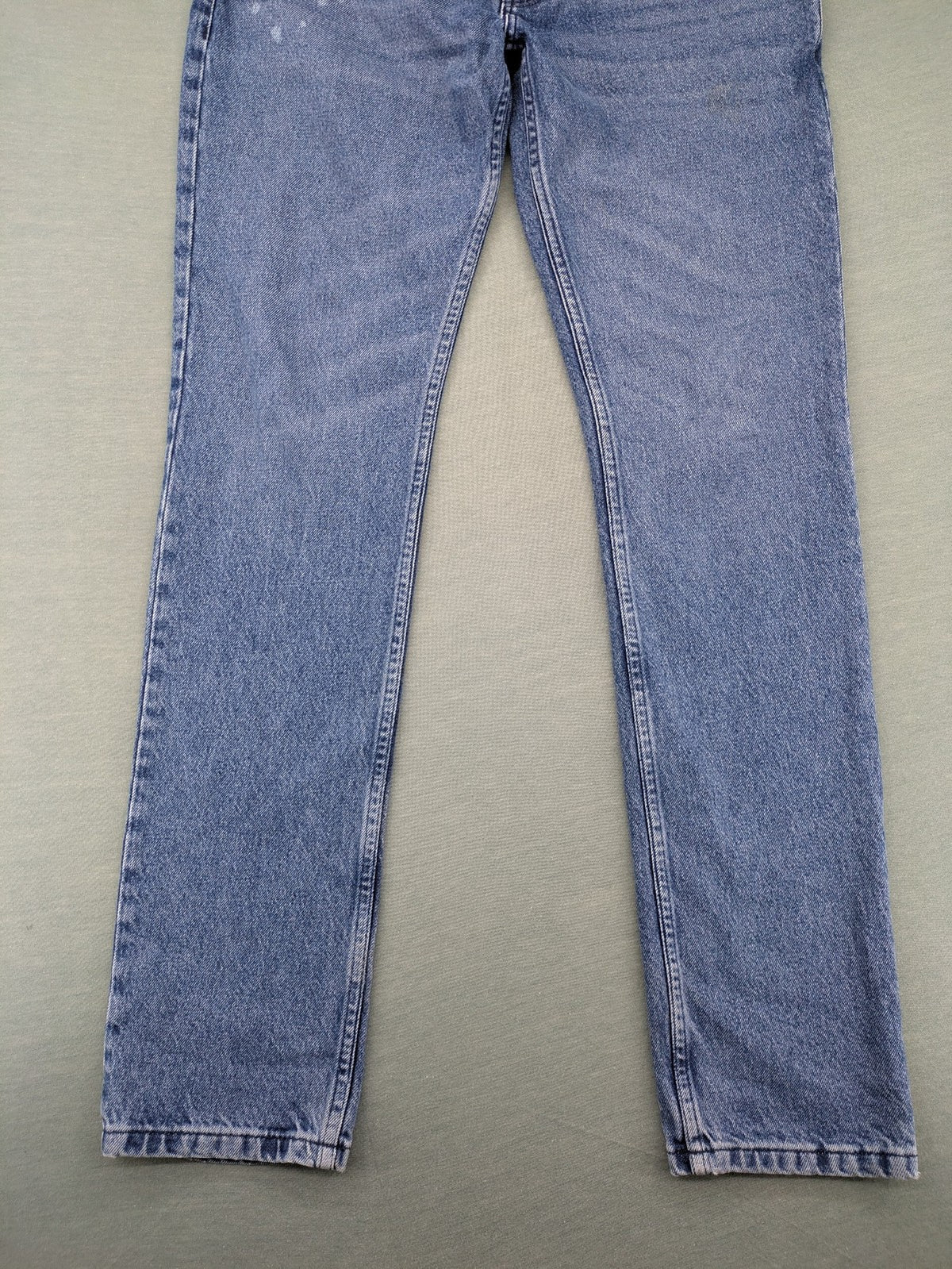 Wrangler blue straight jeans with button fly and classic 5-pocket design.