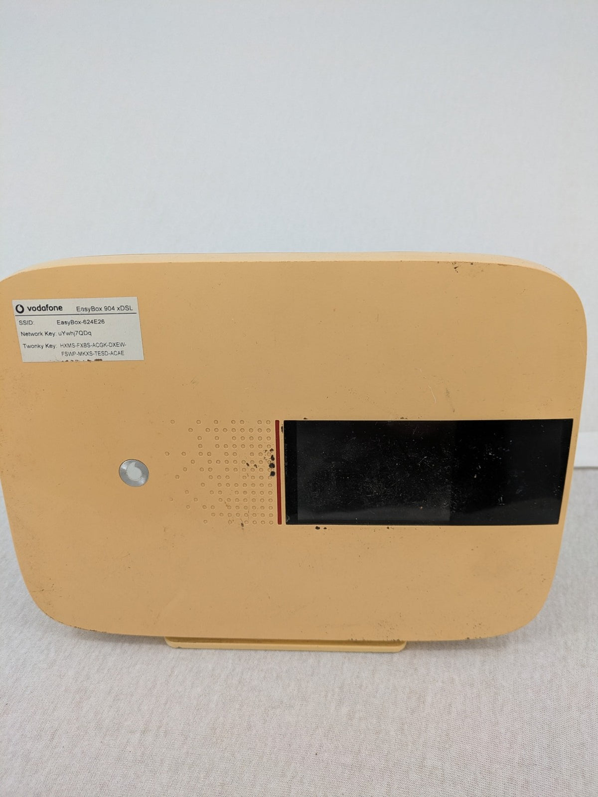 Vodafone beige wireless router with multiple LAN ports and DSL connectivity.