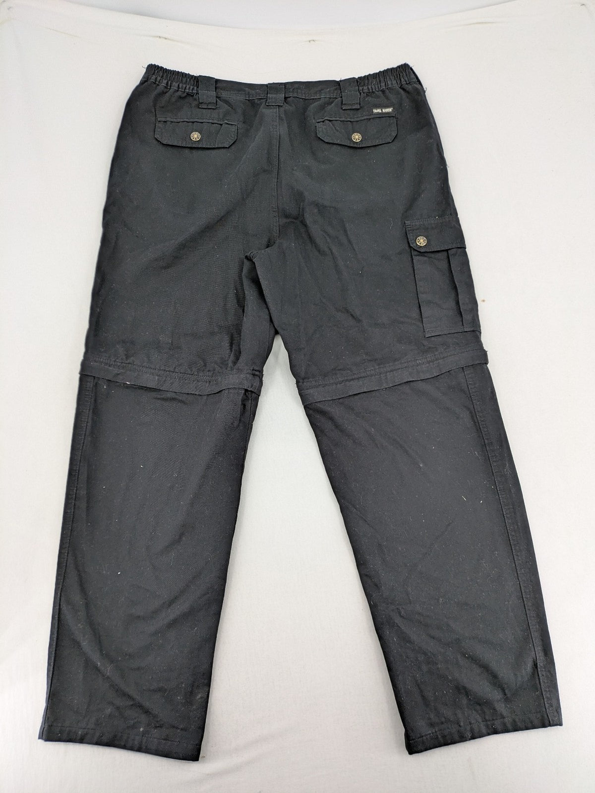 Travel Master black hunting and tactical pants, zip-off design, 100% cotton, multiple pockets.