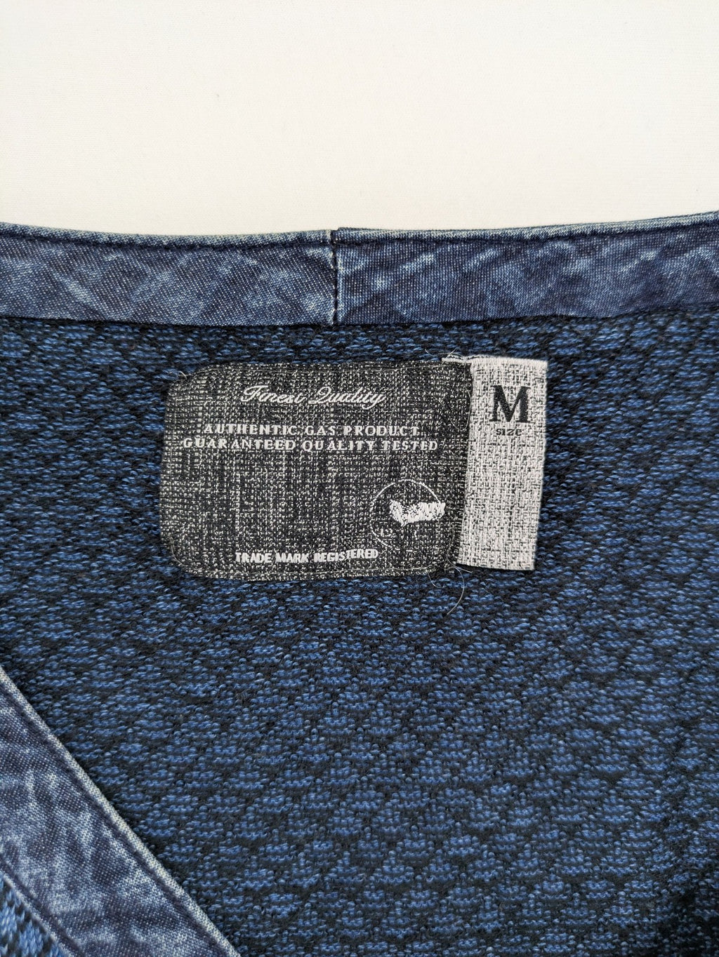 Gas blue turtle neck jumper with diamond pattern, three-button Henley neck, and contrasting trim.