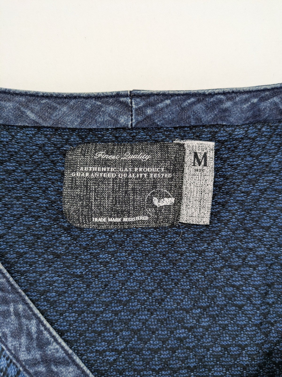 Gas blue turtle neck jumper with diamond pattern, three-button Henley neck, and contrasting trim.