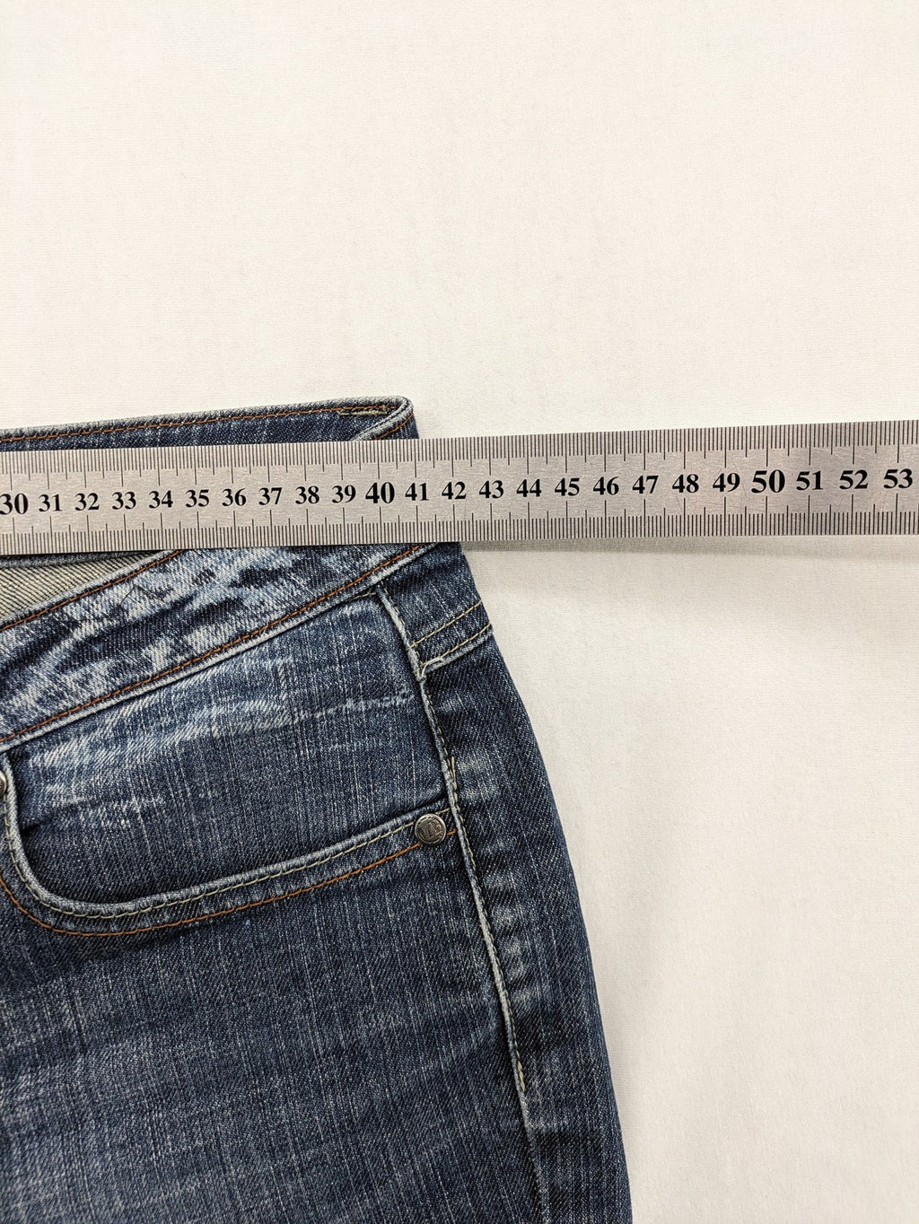 BLU blue straight jeans with washed effect, rolled hem, and five-pocket design.