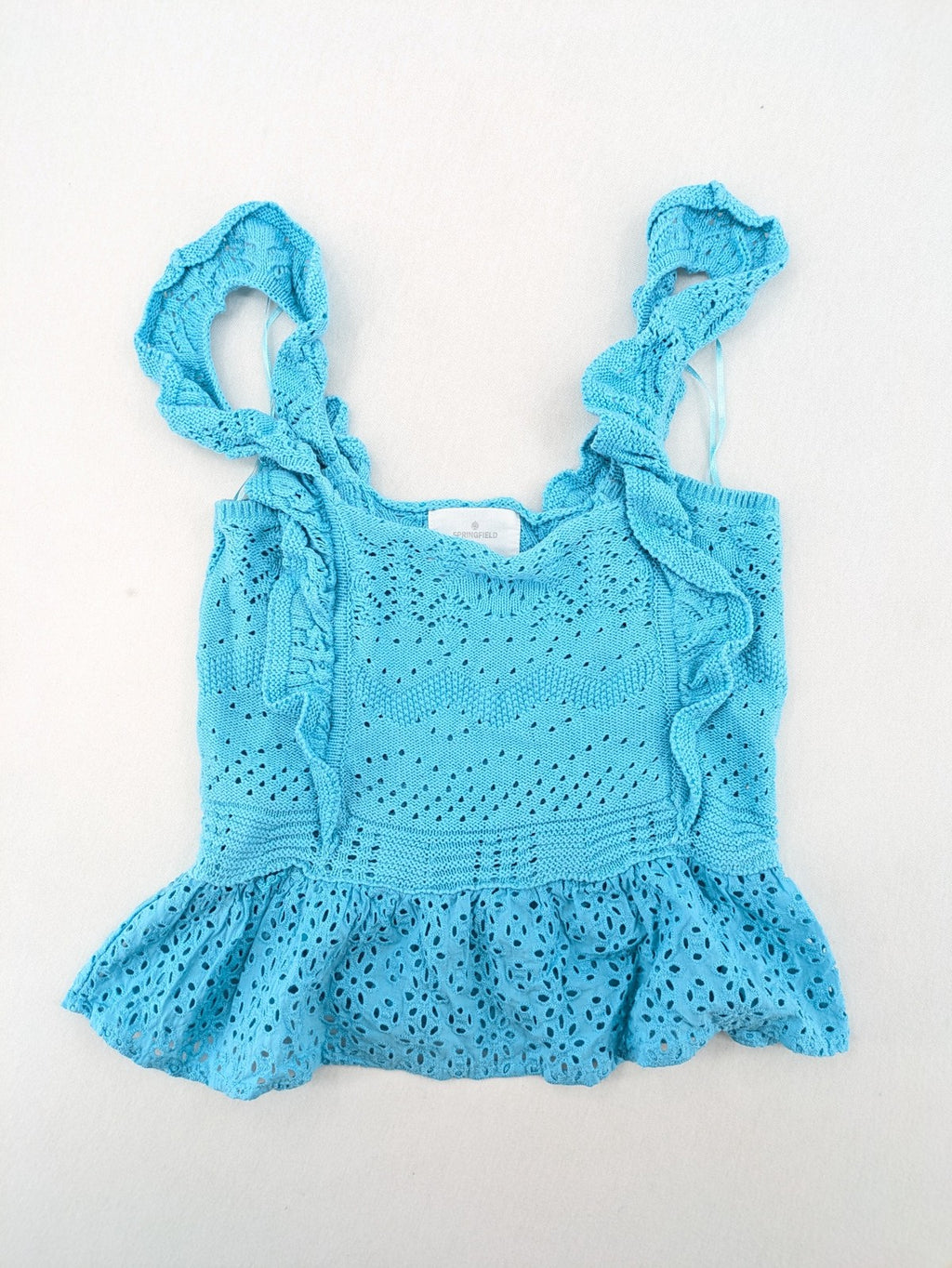 Springfield blue knit top with ruffled straps, peplum hem, and lace embroidery.