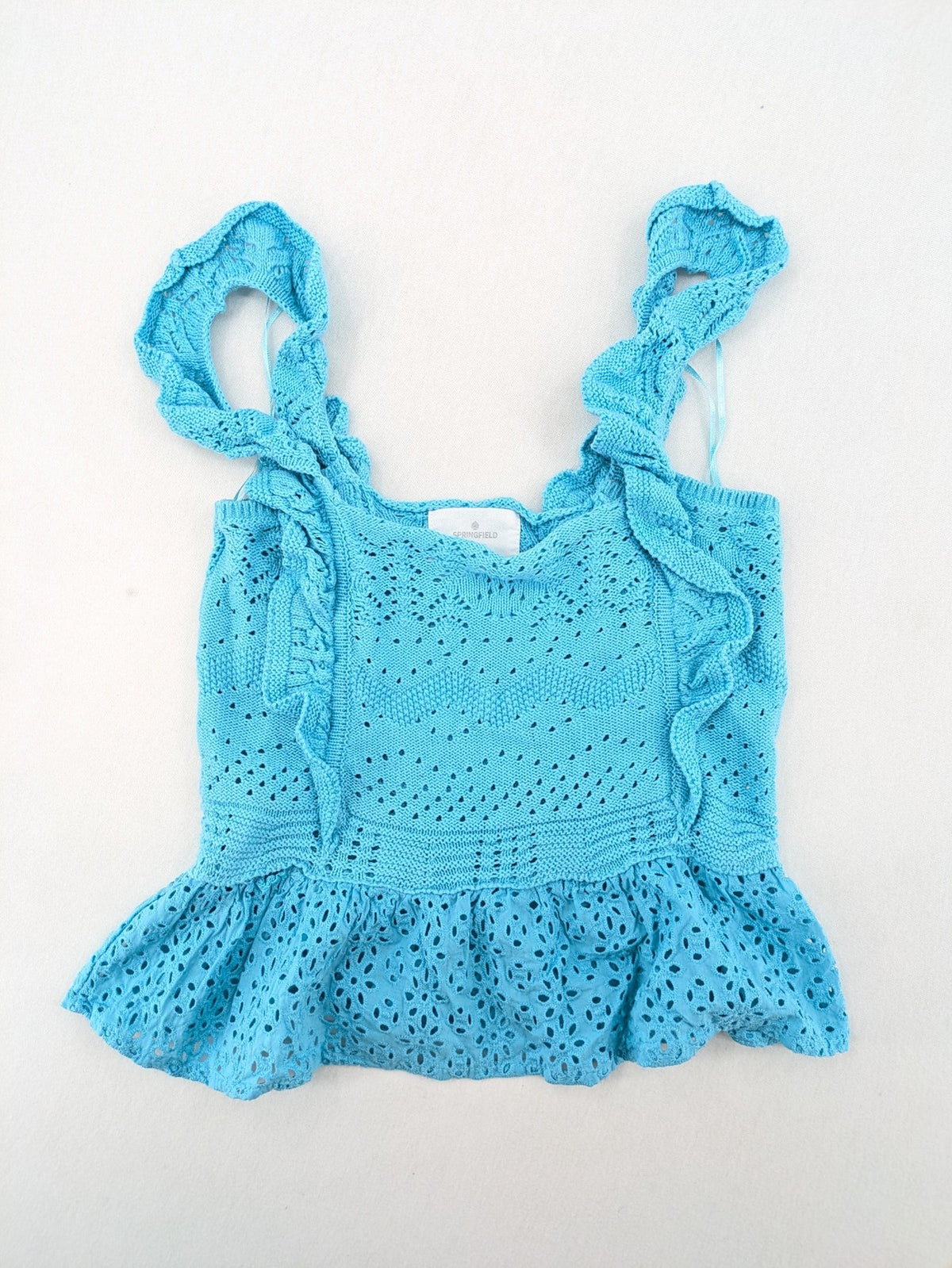Springfield blue knit top with ruffled straps, peplum hem, and lace embroidery.