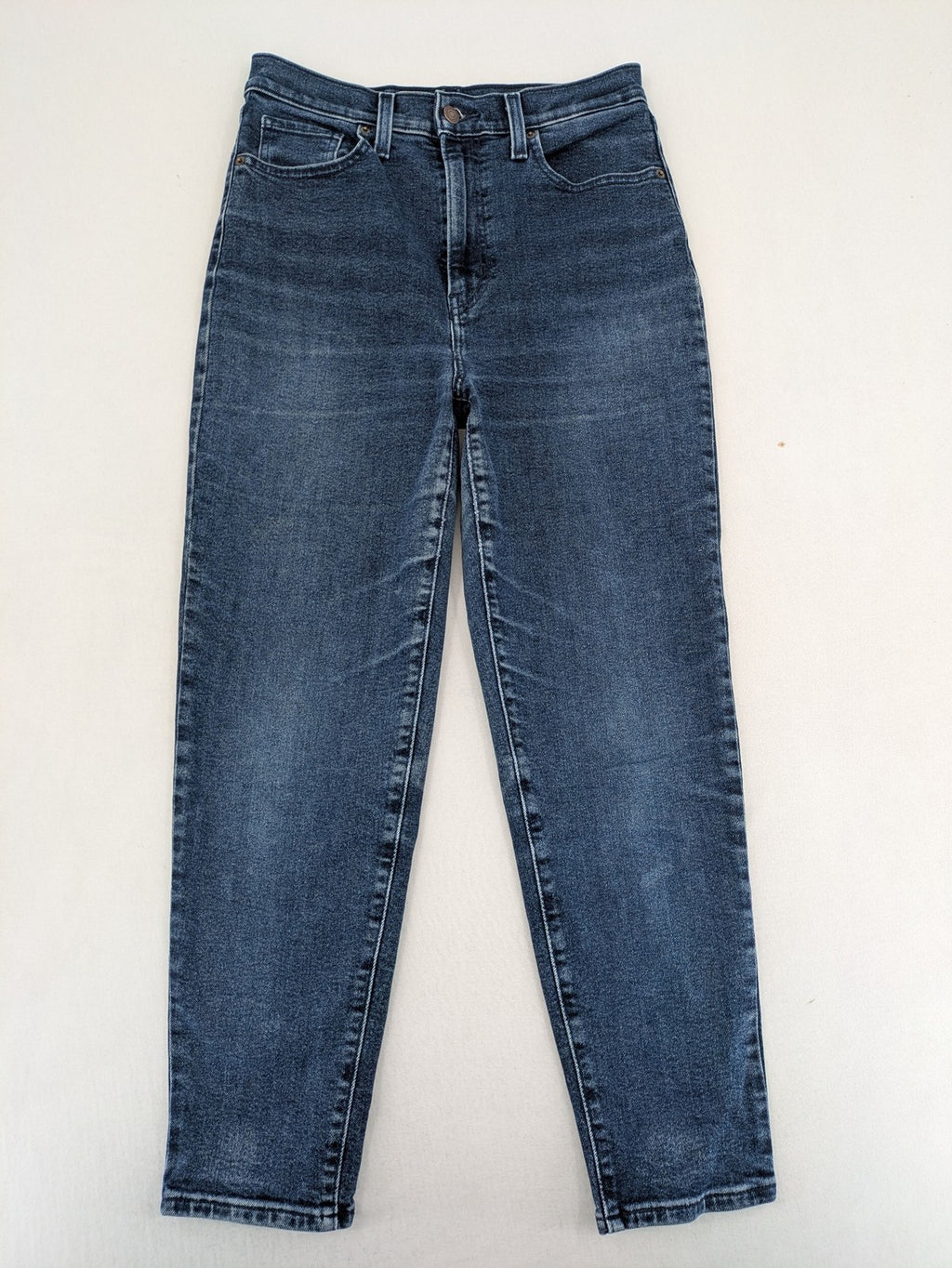 Levi's high waisted taper jeans dark blue 5-pocket design with zipper and stretch material.