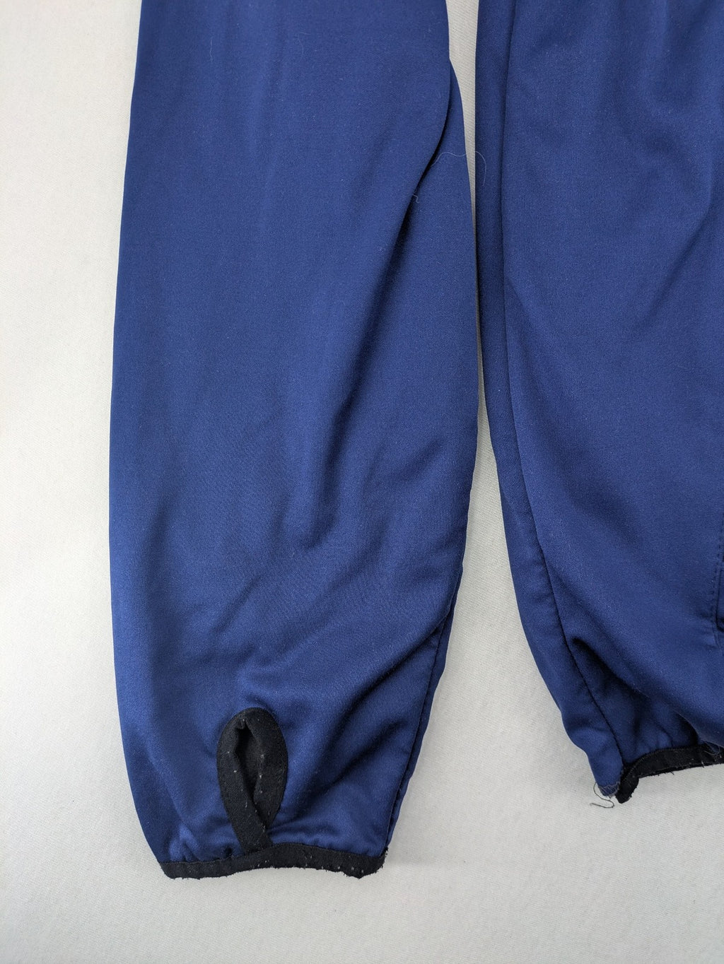 Firefly blue softshell jacket with adjustable hood and prominent chest logo.