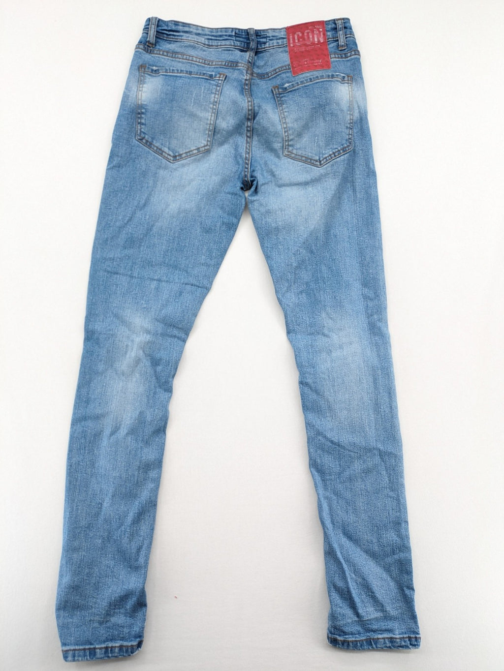 Milano straight jeans light blue distressed with red splatter and extra slim fit.