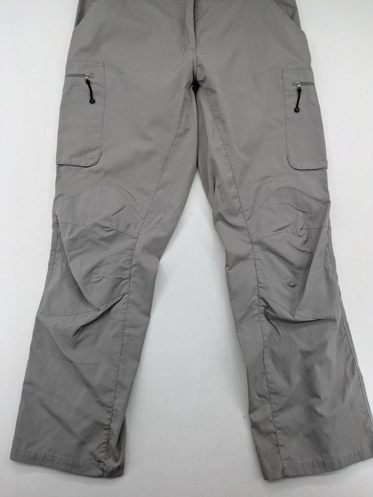 YETI grey cargo pants with multiple zippered pockets and durable material.