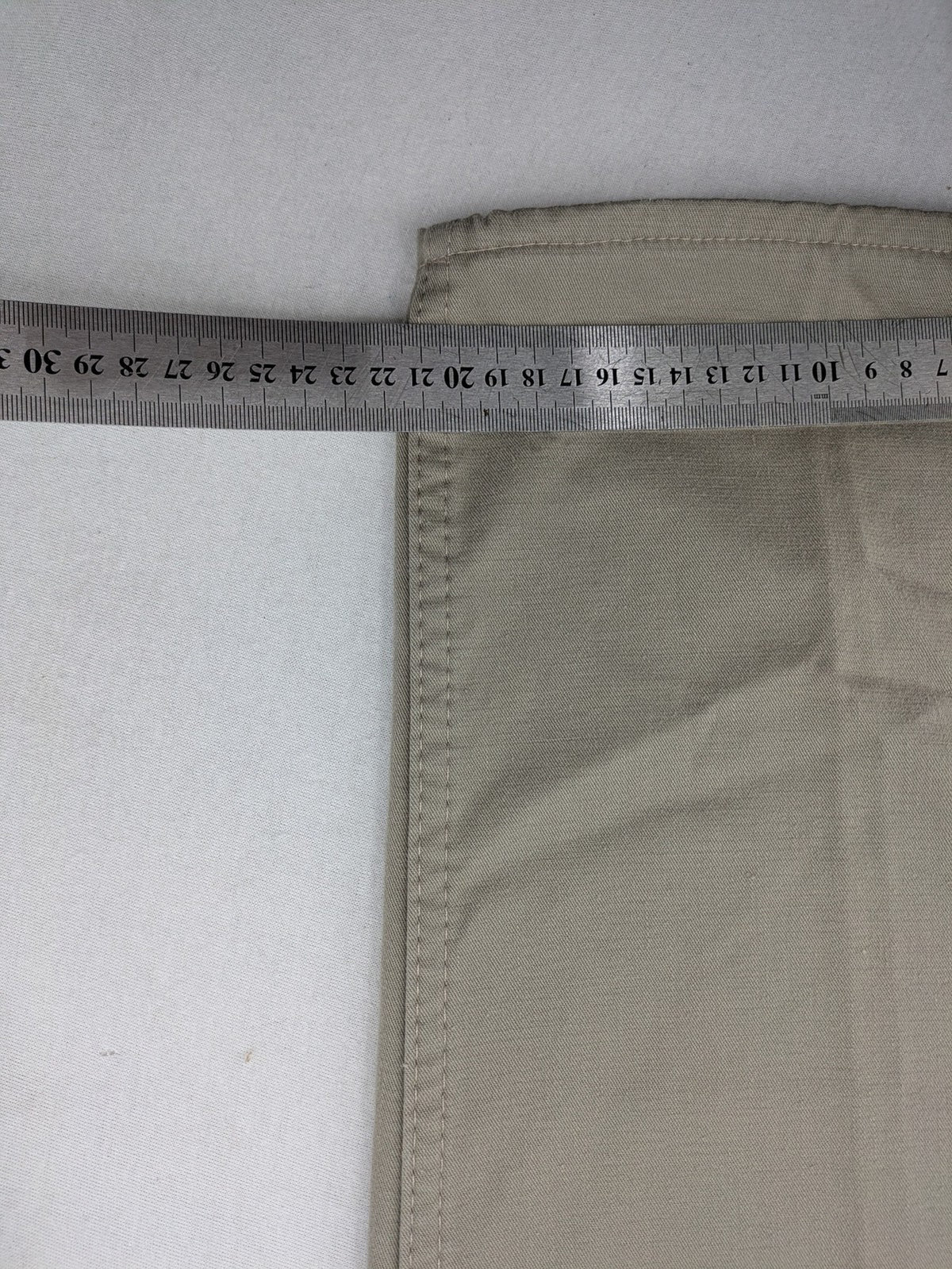 Pioneer beige chino trousers with pleats, straight leg, and buttoned back pocket.