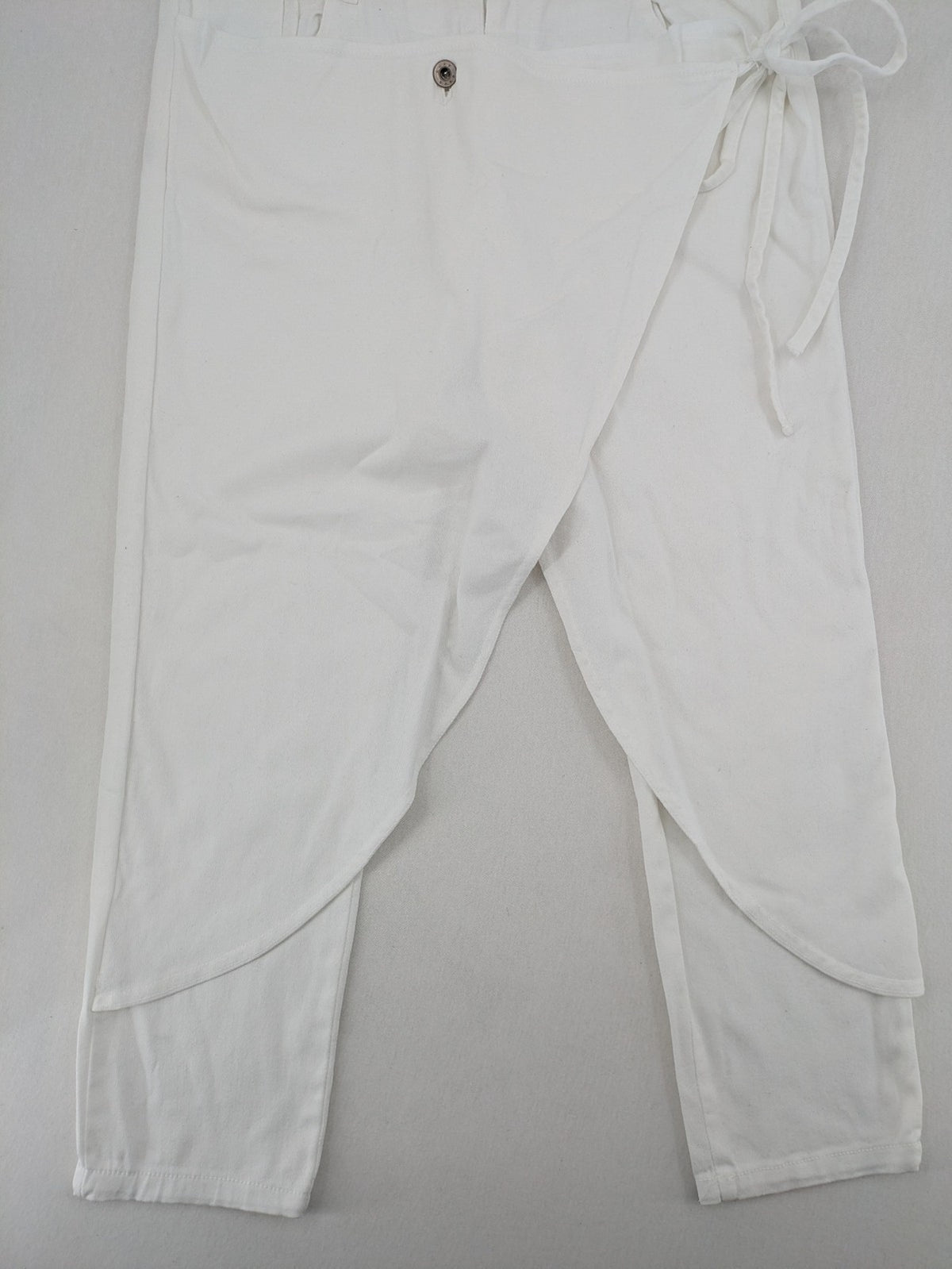 New Collection white straight jeans asymmetrical wrap design with side lacing and cotton-stretch material.