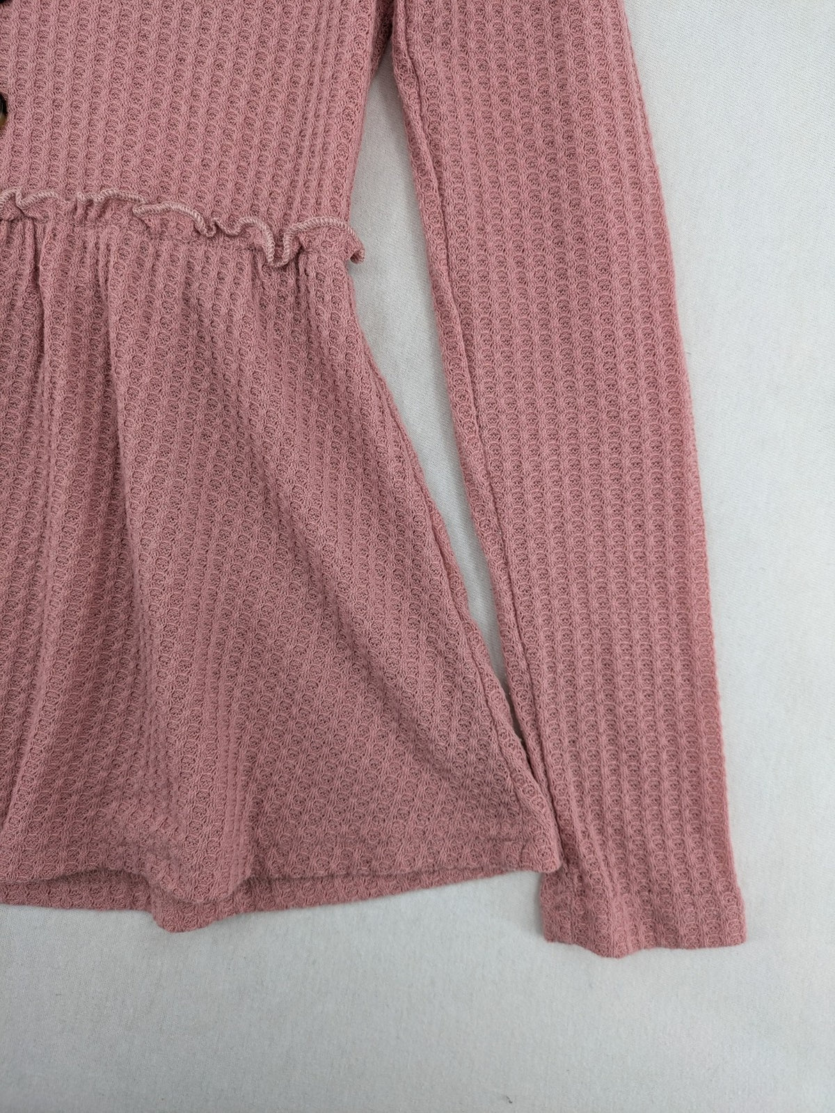 SHEIN pink top V-neck with ruffled waist and three decorative buttons, waffle knit fabric.
