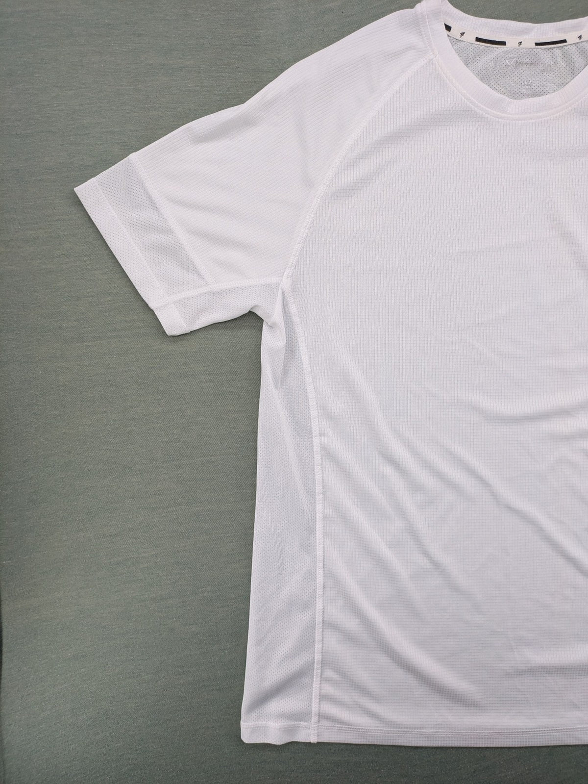 Smilodox white workout t-shirt with logo on chest and reflective detail on back.