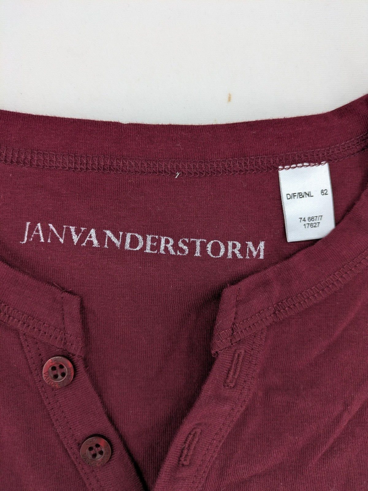 Jan Vanderstorm burgundy Henley shirt with button placket and "087 JV DEPT" graphic print.