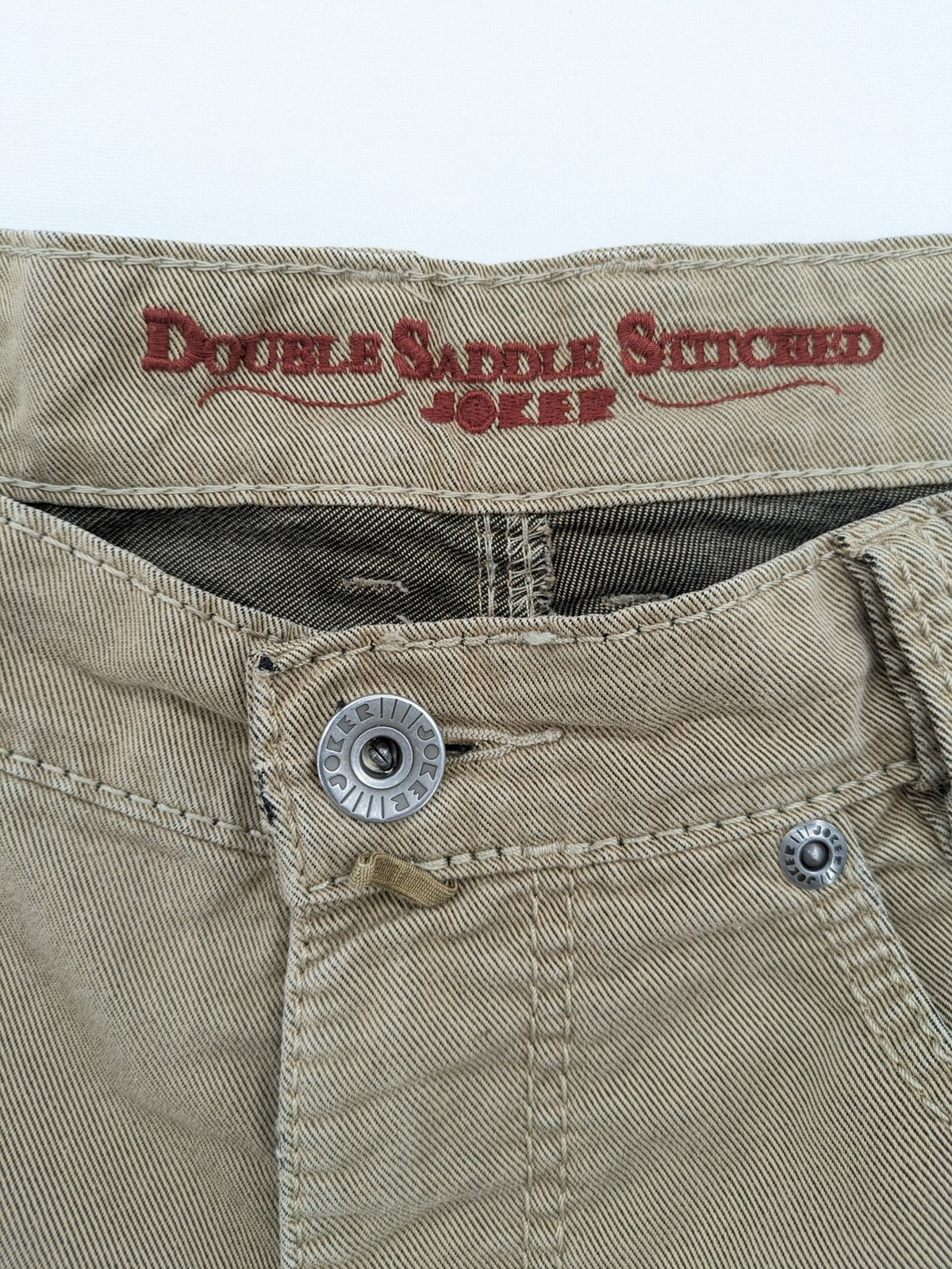 Joker beige straight jeans with double saddle stitching and classic 5-pocket design.