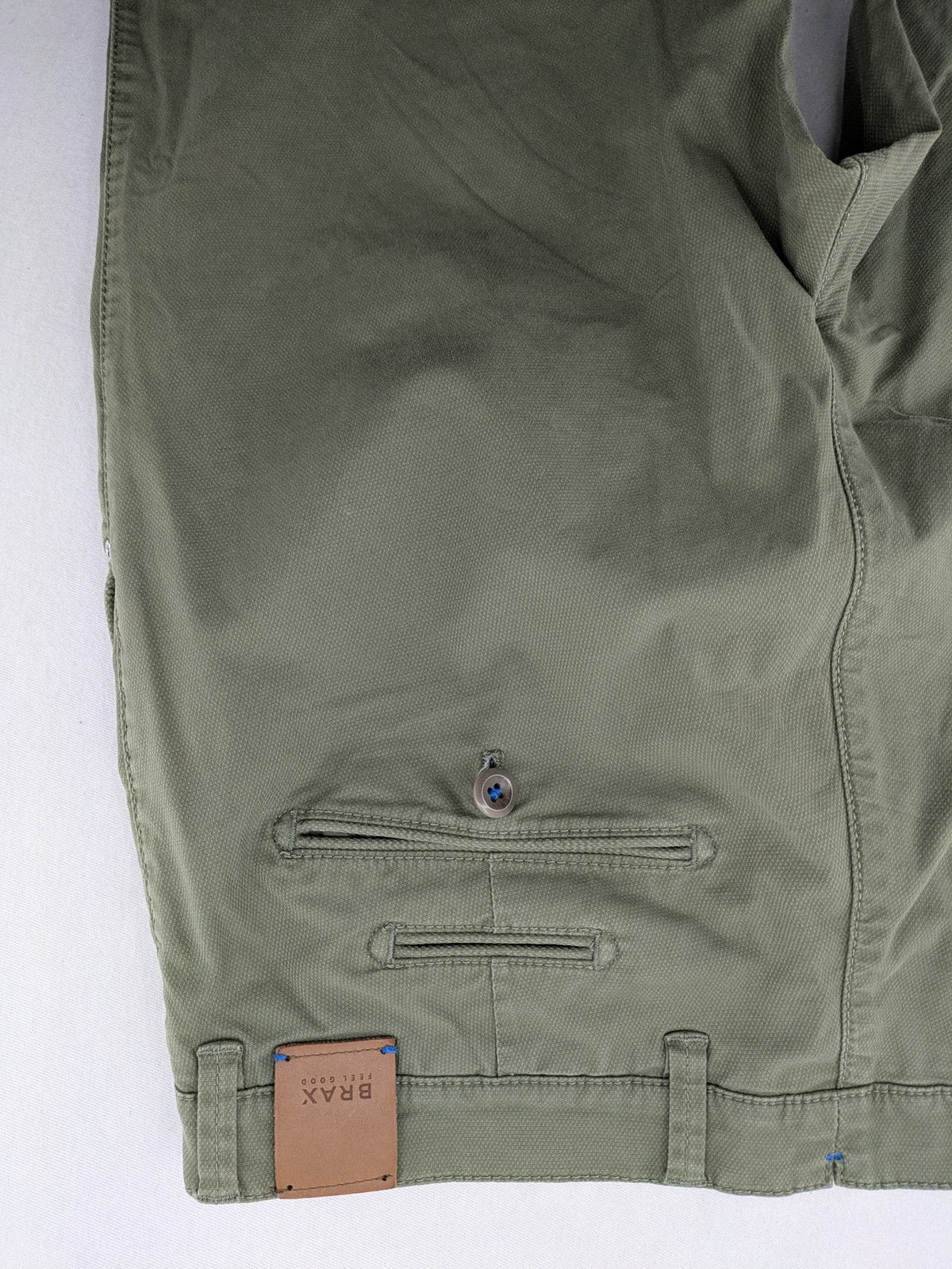 BRAX green chino pants flat-front design with zipper and buttoned back pockets.