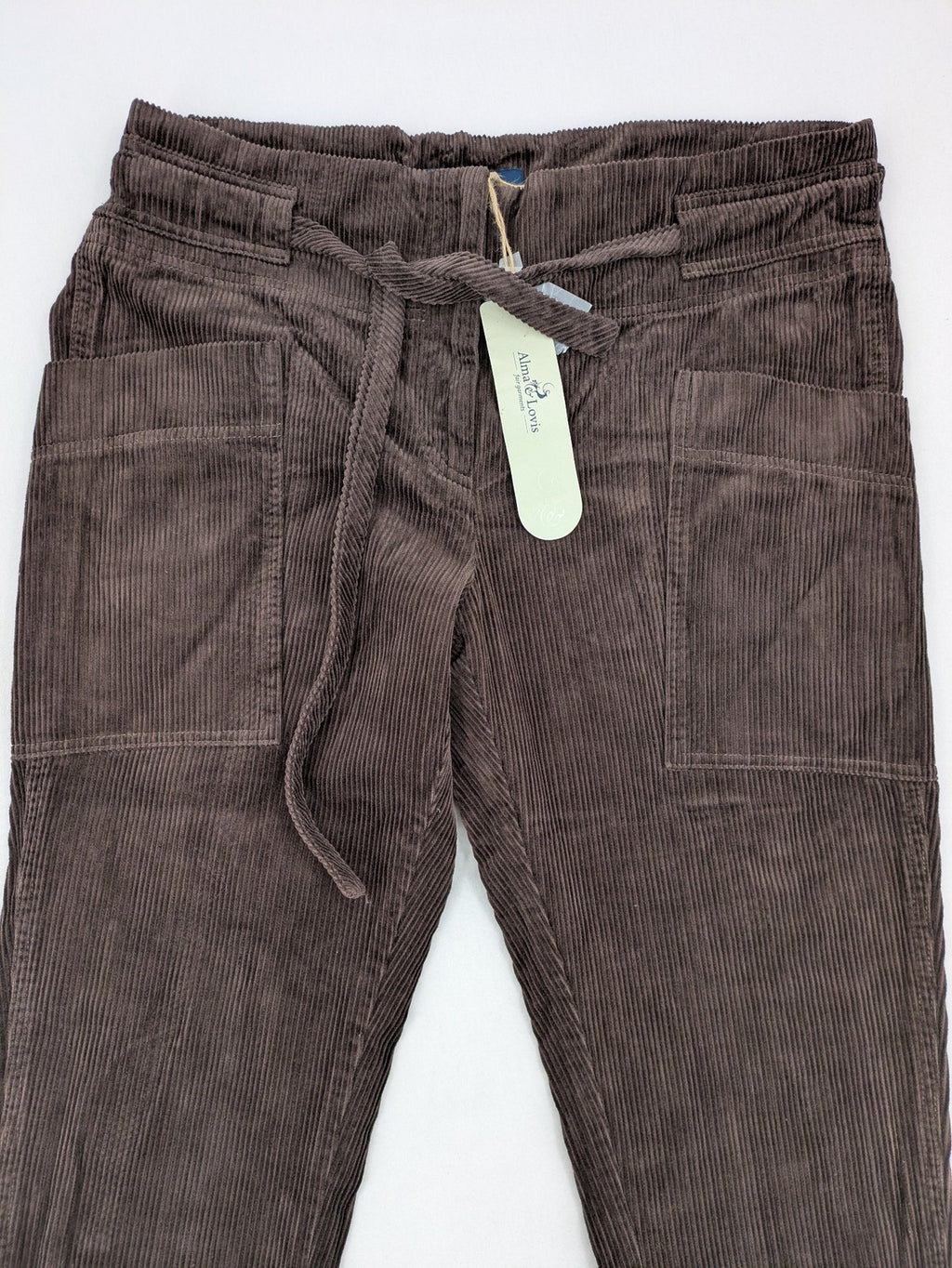 Alma & Lovis brown cord pants with elastic waistband, drawstring, and front patch pockets.