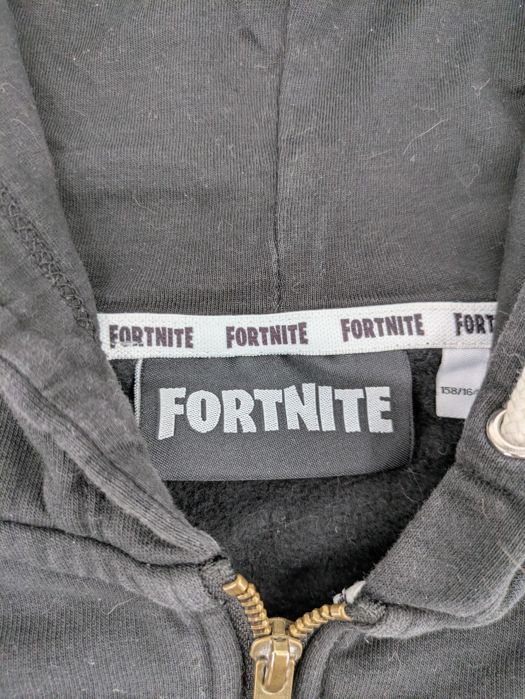 Fortnite black zip-through hoodie with logo on sleeves and Black Knight patch on chest.