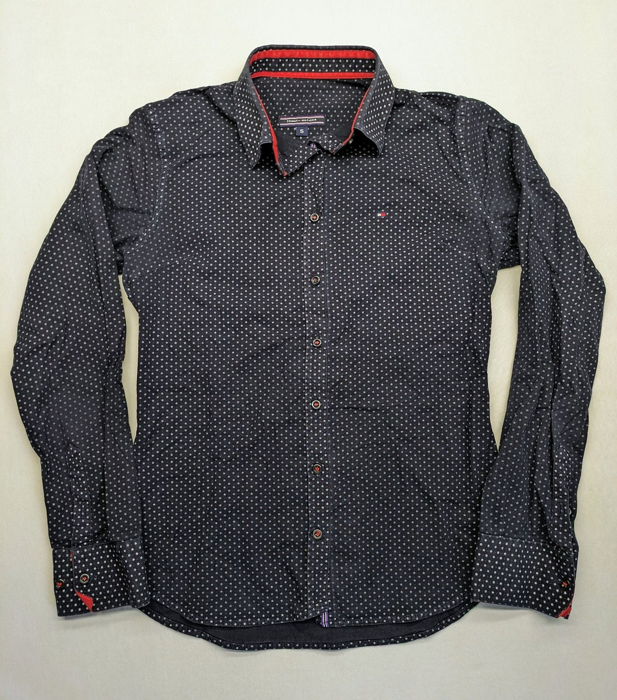Tommy Hilfiger navy button-down shirt with white star pattern and embroidered flag logo.