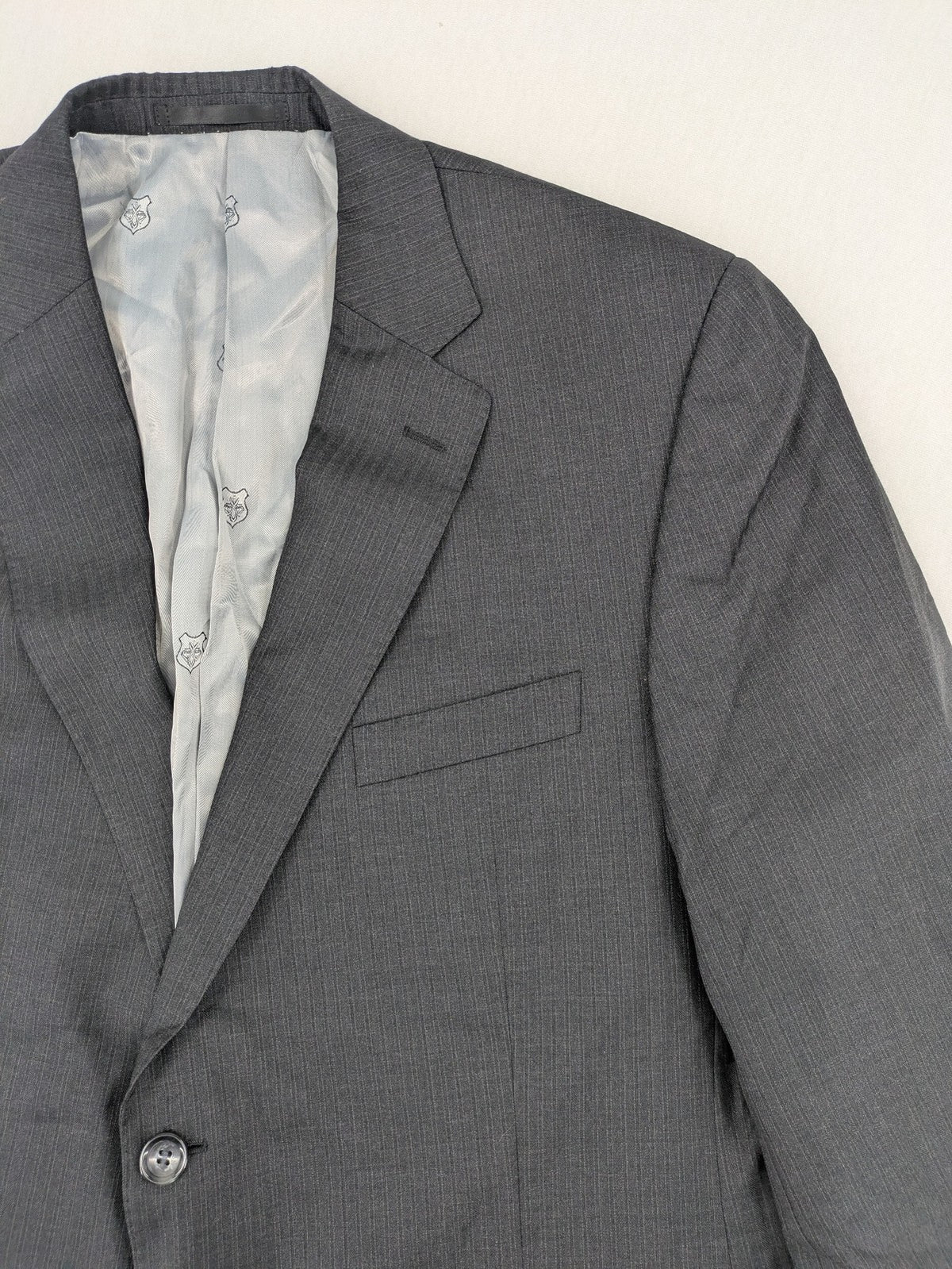 Desch grey blazer with dark grey pinstripe pattern, satin lining, and tailored design.