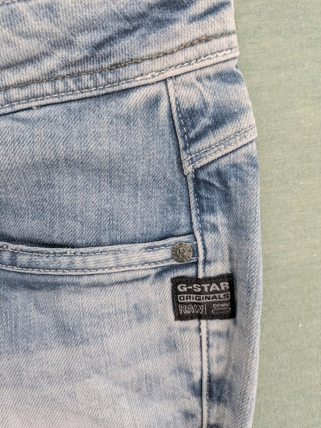 G-Star Raw blue straight leg jeans with classic 5-pocket design and light wash denim.