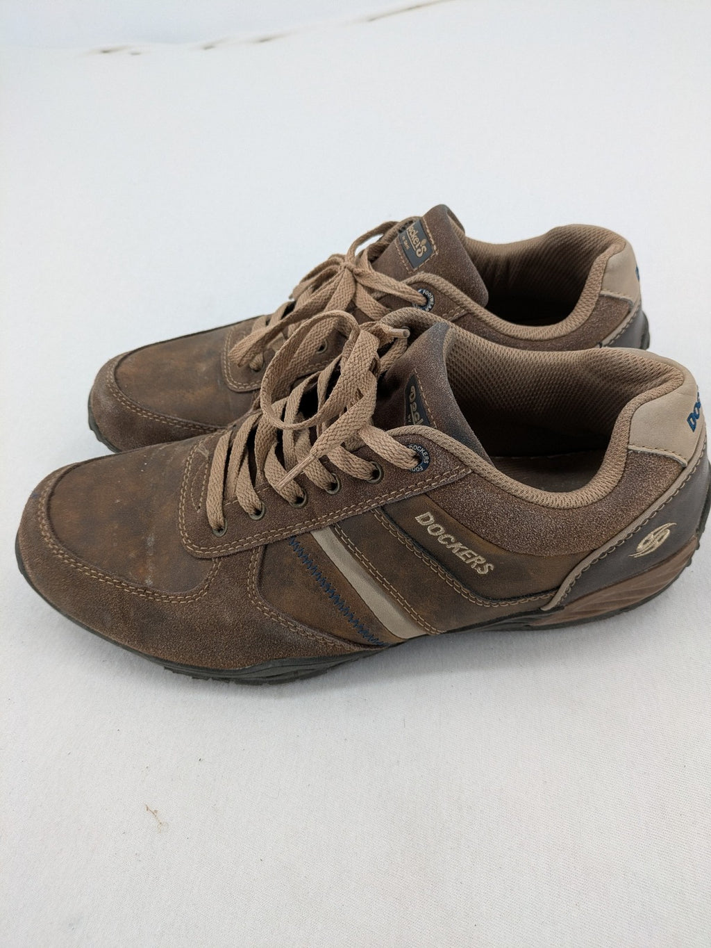Dockers brown sneakers with subtle light brown and blue accents, lace-up design.