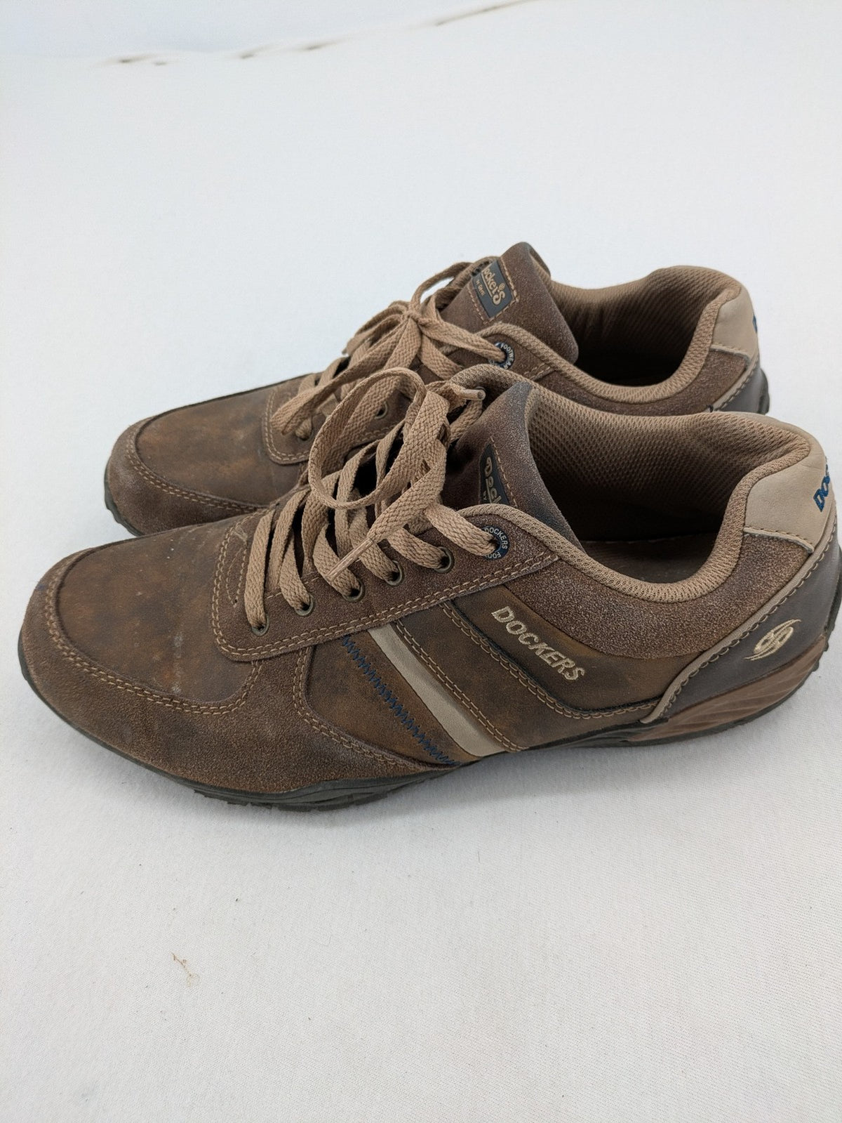 Dockers brown sneakers with subtle light brown and blue accents, lace-up design.