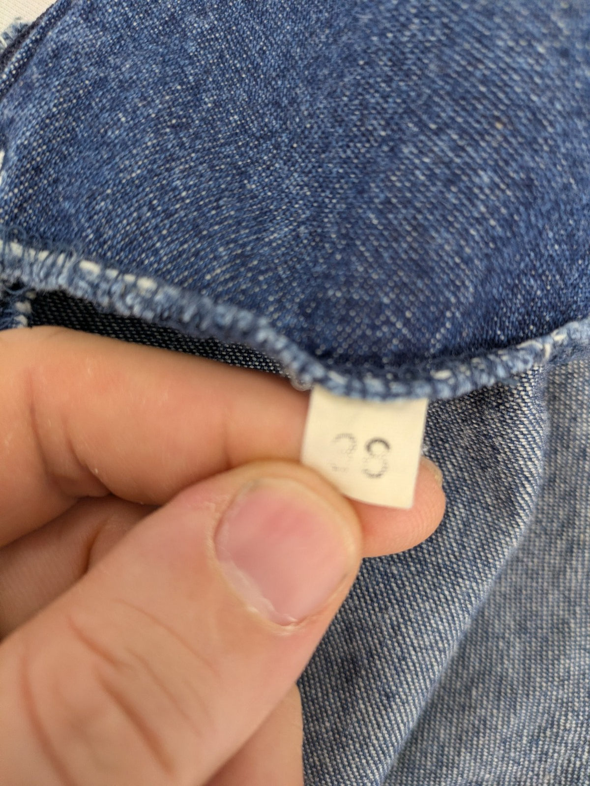 Damen blue denim mini dress with all-over white and light blue floral embroidery.