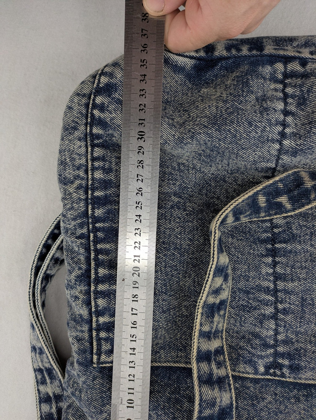 Clockhouse blue acid wash denim tote bag with adjustable shoulder strap and classic handles.