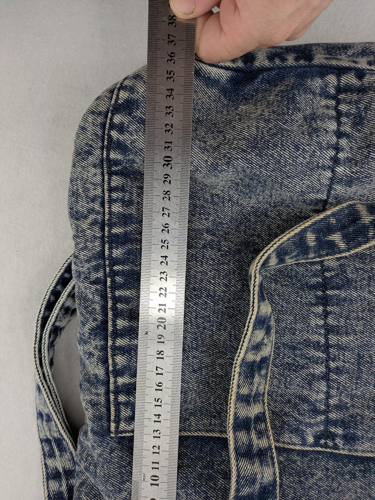Clockhouse blue acid wash denim tote bag with adjustable shoulder strap and classic handles.