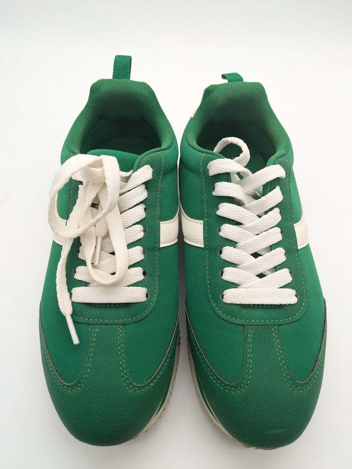 Primark green and white retro sneakers with classic lace-up design and textured rubber sole.