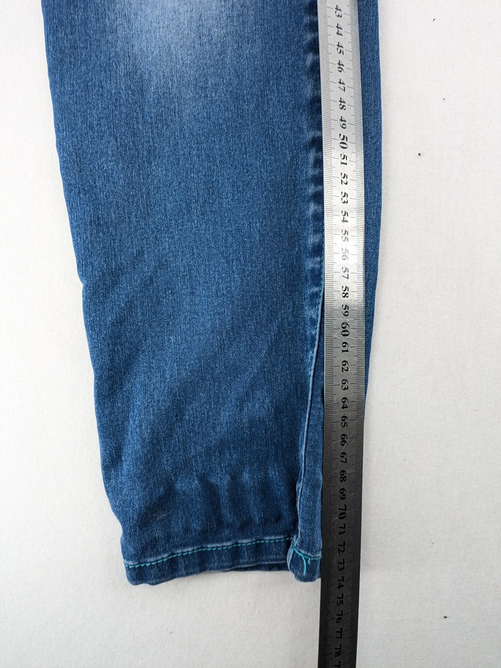 Rainbow blue straight jeans jogger style with button fly and contrasting turquoise stitching.