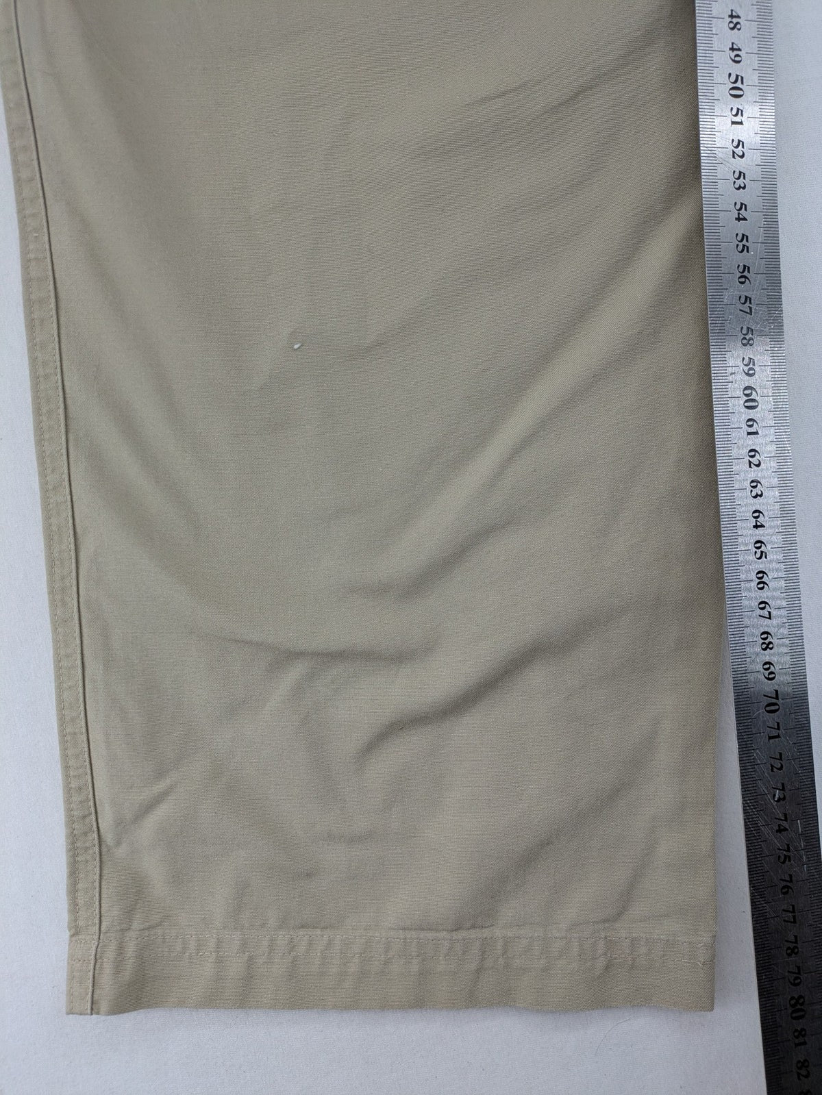 Quechua khaki convertible hiking pants with zip-off legs and durable cotton fabric.