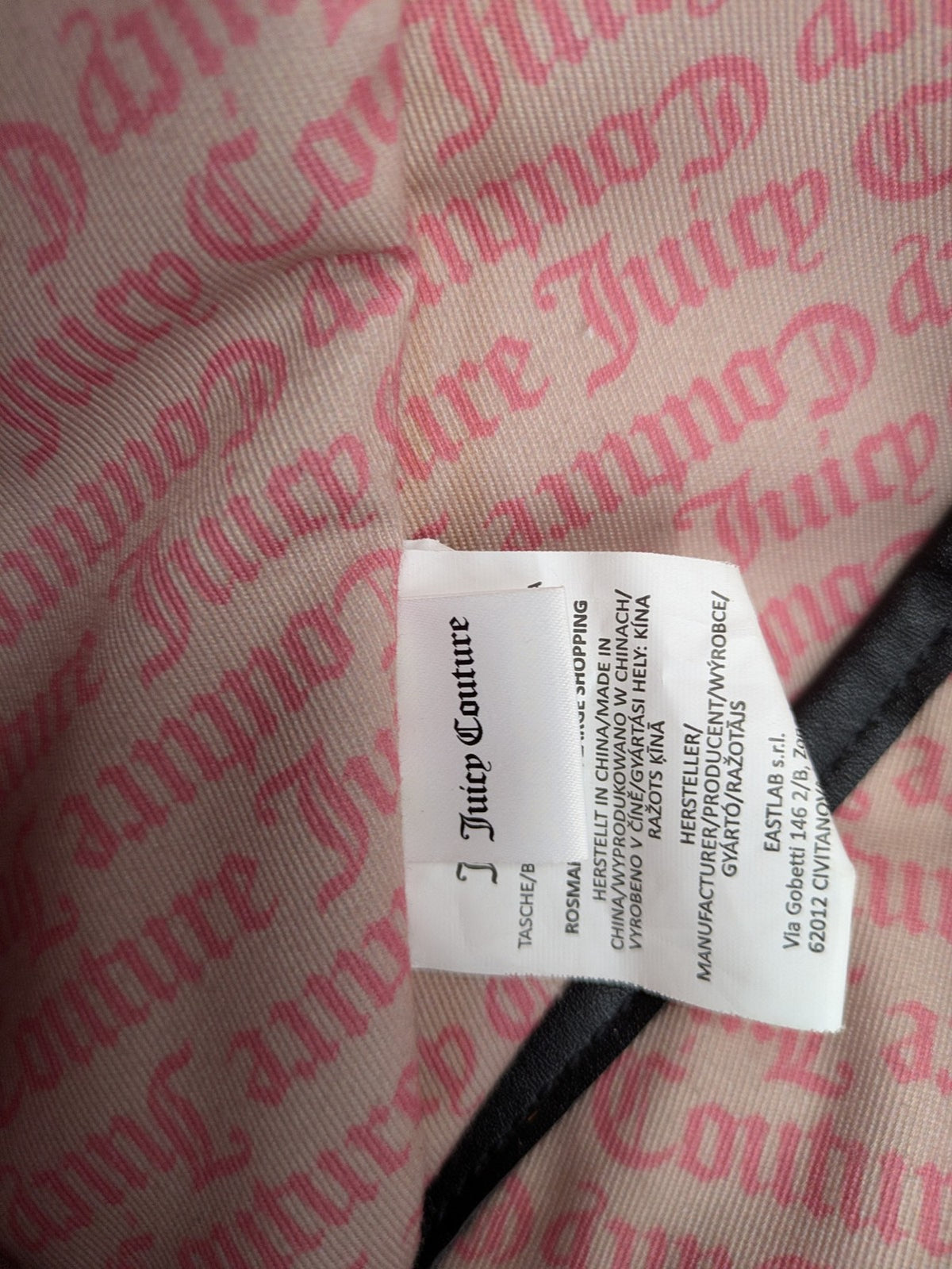 Juicy Couture pink velour handbag with oversized black logo and faux leather straps.