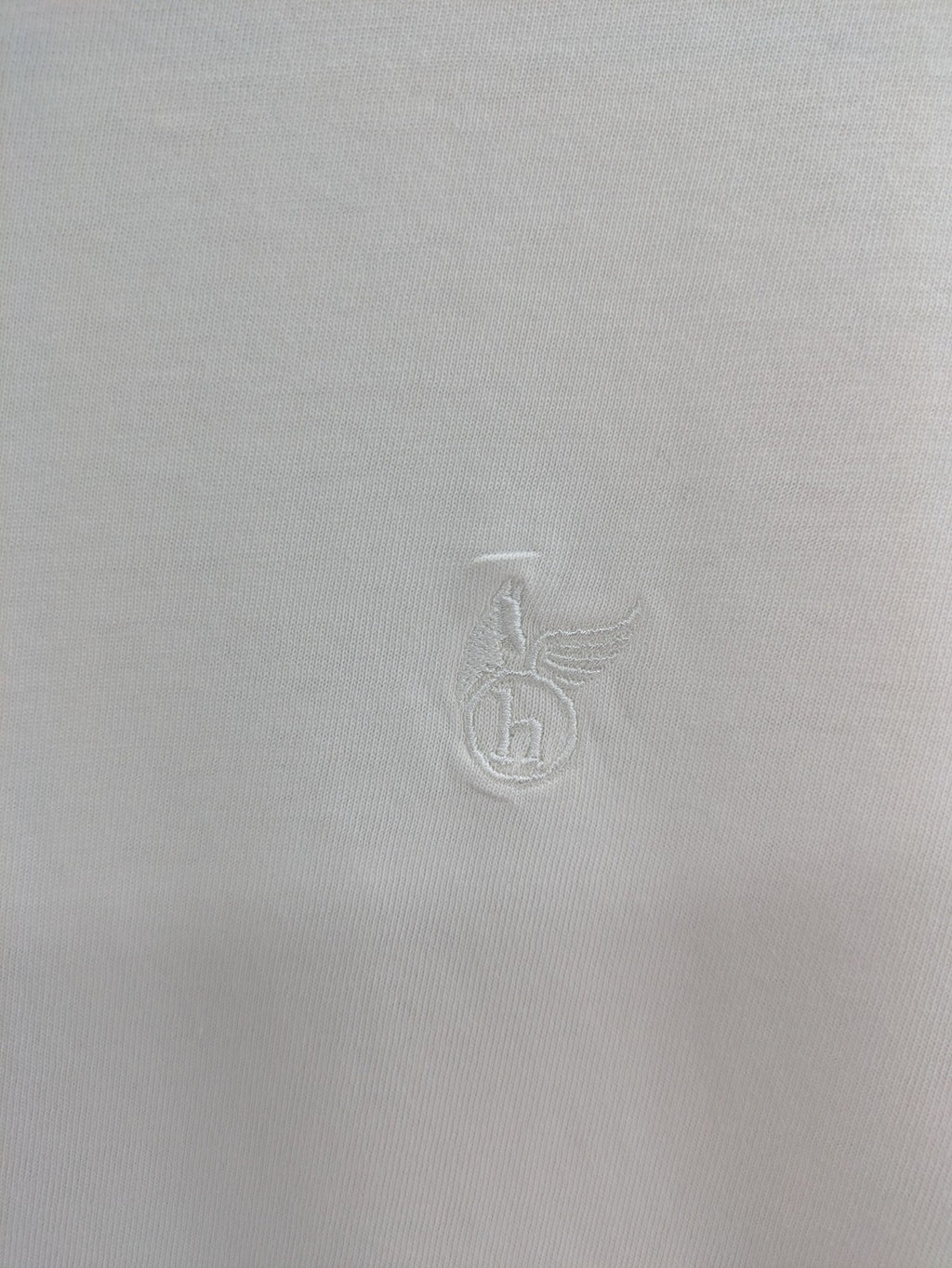 Hajo white short-sleeve t-shirt with subtle logo embroidery and side slits.