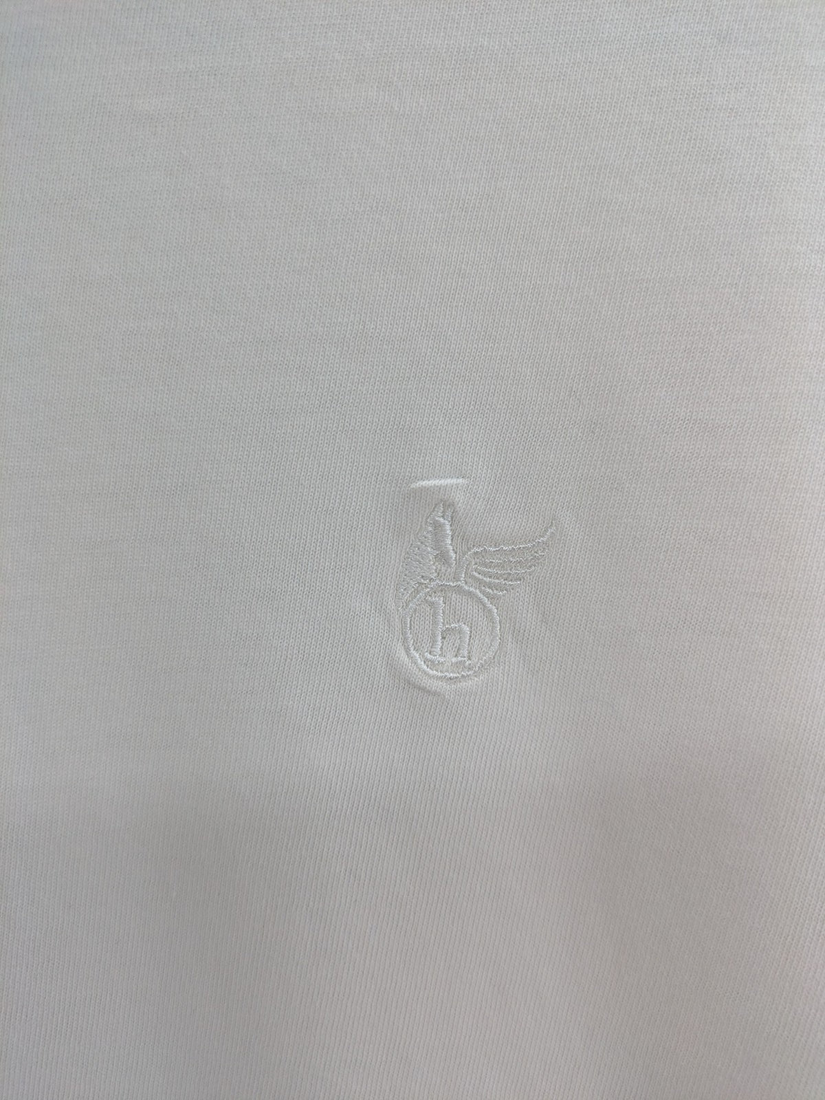 Hajo white short-sleeve t-shirt with subtle logo embroidery and side slits.