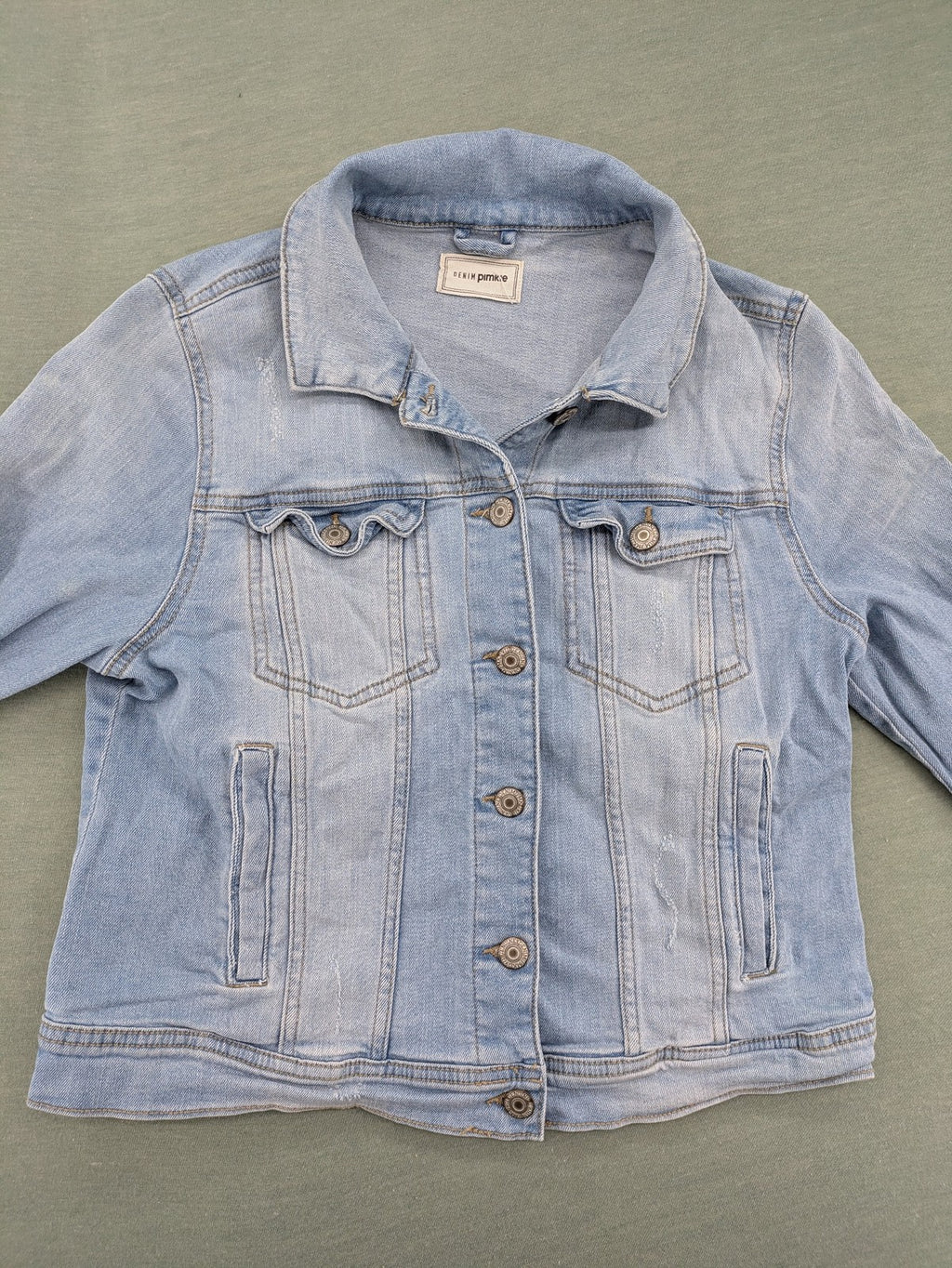 Pimkie blue denim jacket with classic cut, button placket, and two chest pockets.