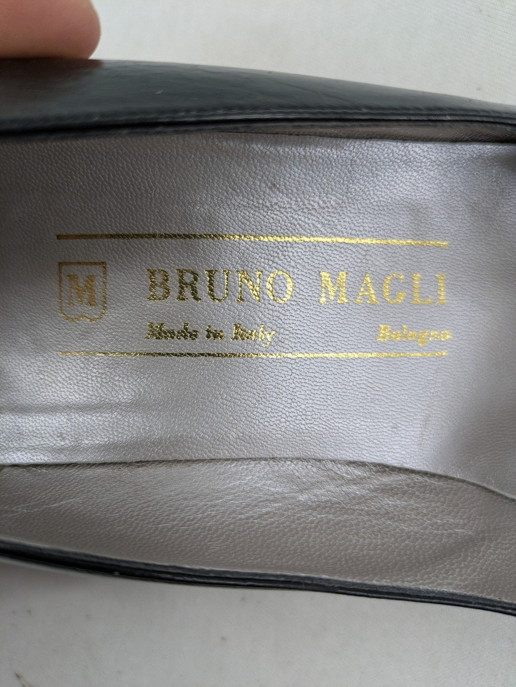 Bruno Magli black high heels leather with grey bow detail and classic silhouette.