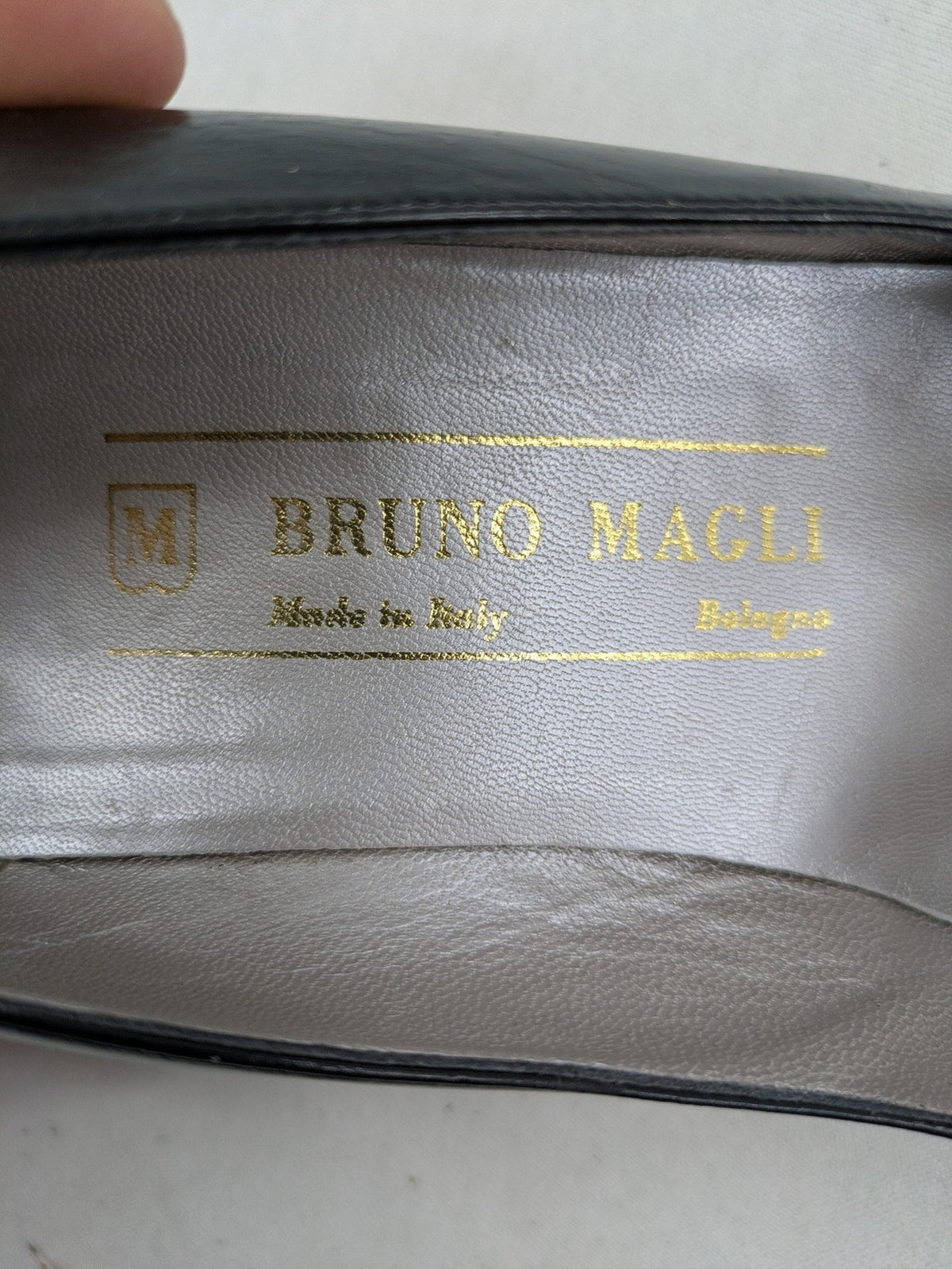Bruno Magli black high heels leather with grey bow detail and classic silhouette.