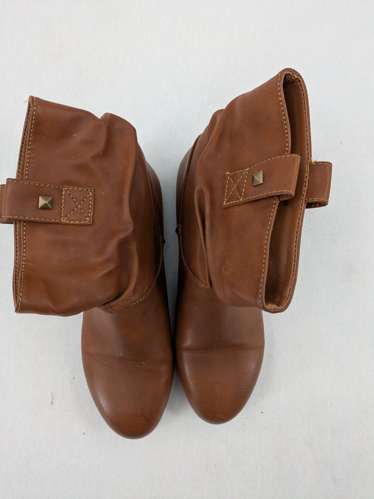 Van Hill brown ankle boots with slouchy design, fold-over cuff, and soft lining.