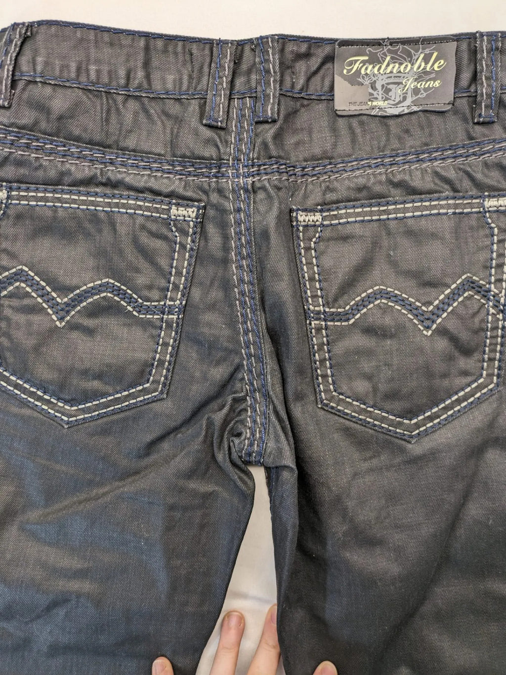 Fadnoble grey straight jeans with button fly and contrasting stitching details.