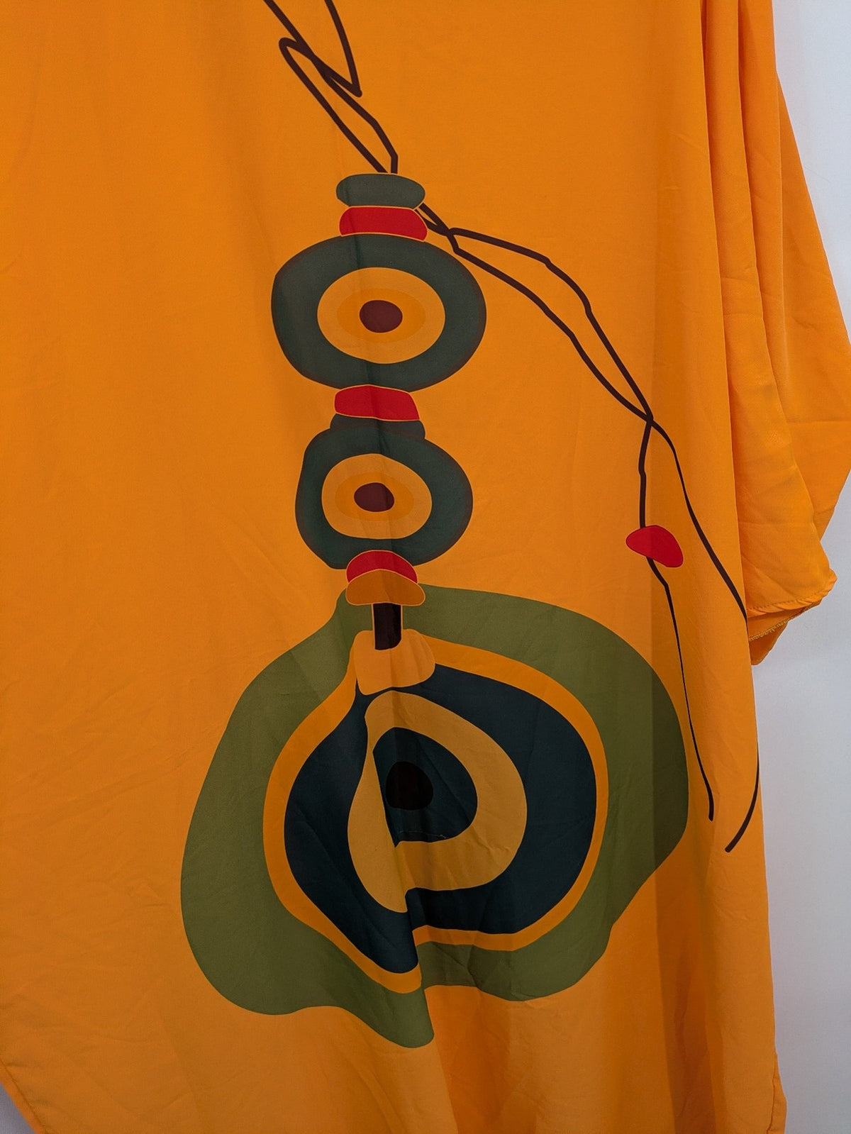 Kaftan orange oversized summer dress with unique graphic print and long sleeves.
