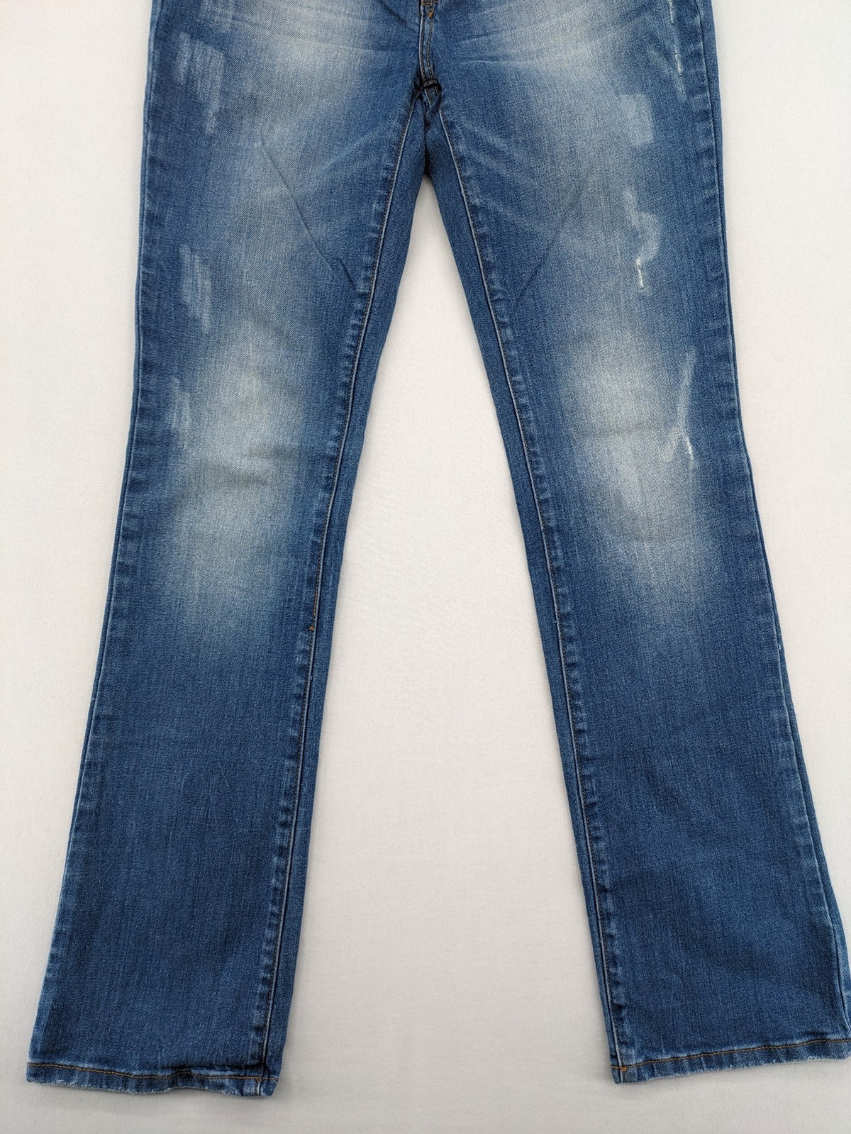Denim blue straight jeans low rise bootcut with classic 5-pocket design and subtle rivets.