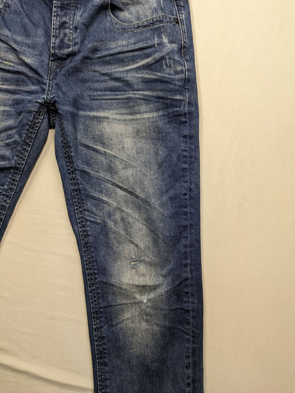 Brandit blue straight jeans with distressed details, button fly, and classic 5-pocket style.